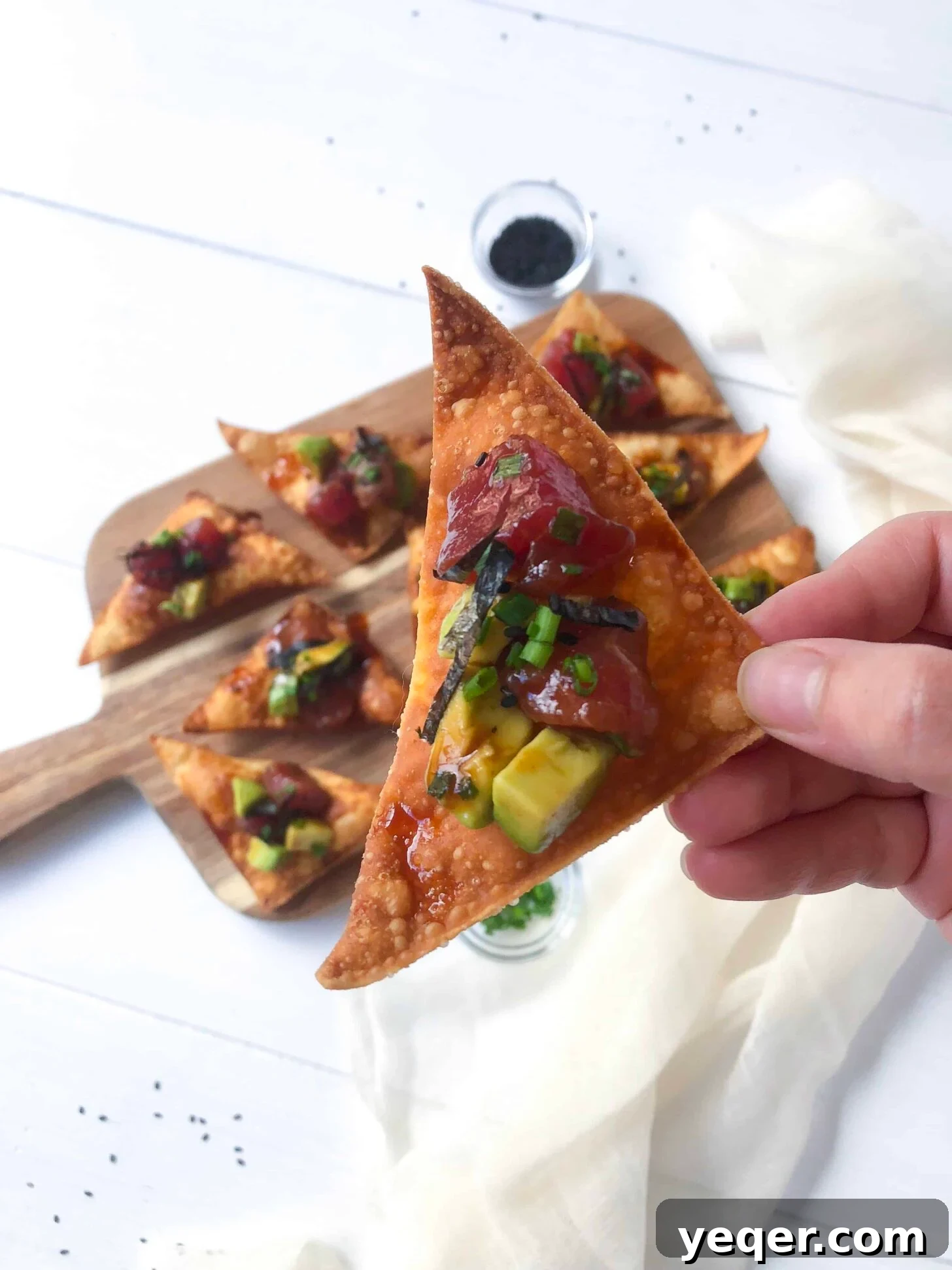 Fresh Tuna Avocado Poke Tapas with Crunchy Wonton Dippers 3 A cutting board with avocado tuna poke tapas