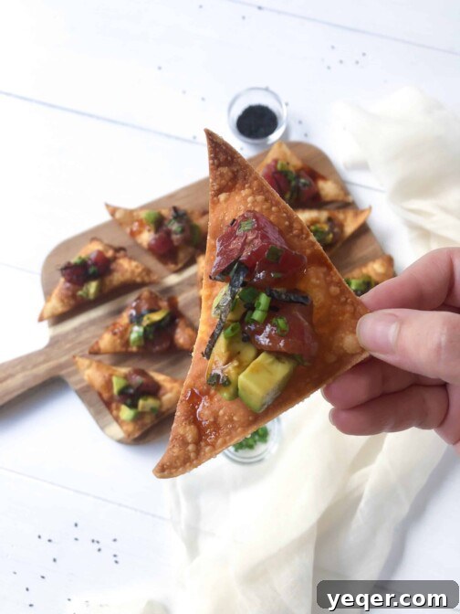 A cutting board with avocado tuna poke tapas