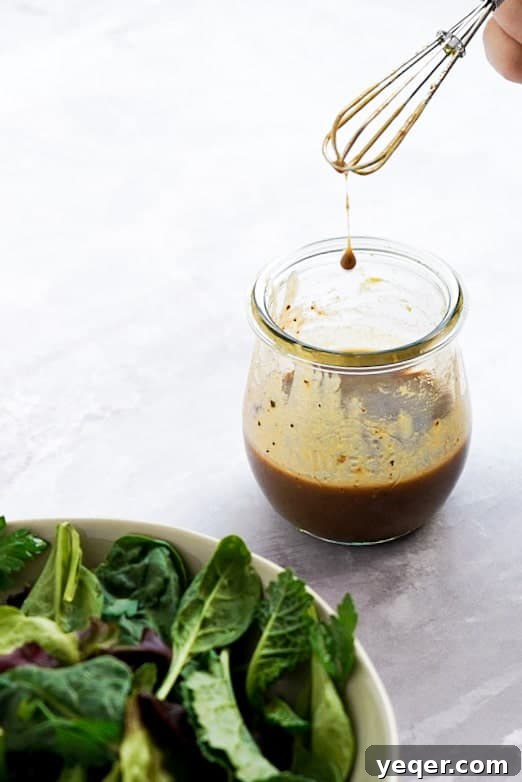Five Expert Tips for Mouthwatering Food Photos 3 A jar of classic balsamic dressing with a fresh salad subtly visible in the corner, conveying a real-life dining setup.