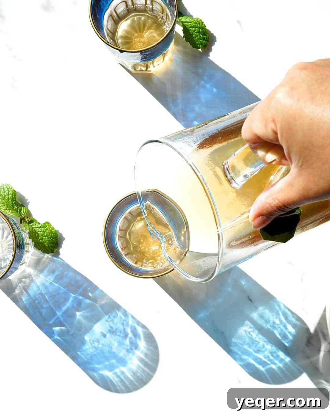Five Expert Tips for Mouthwatering Food Photos 4 Three elegant blue Moroccan tea glasses, with tea gracefully pouring into one, showcasing thoughtful prop placement.
