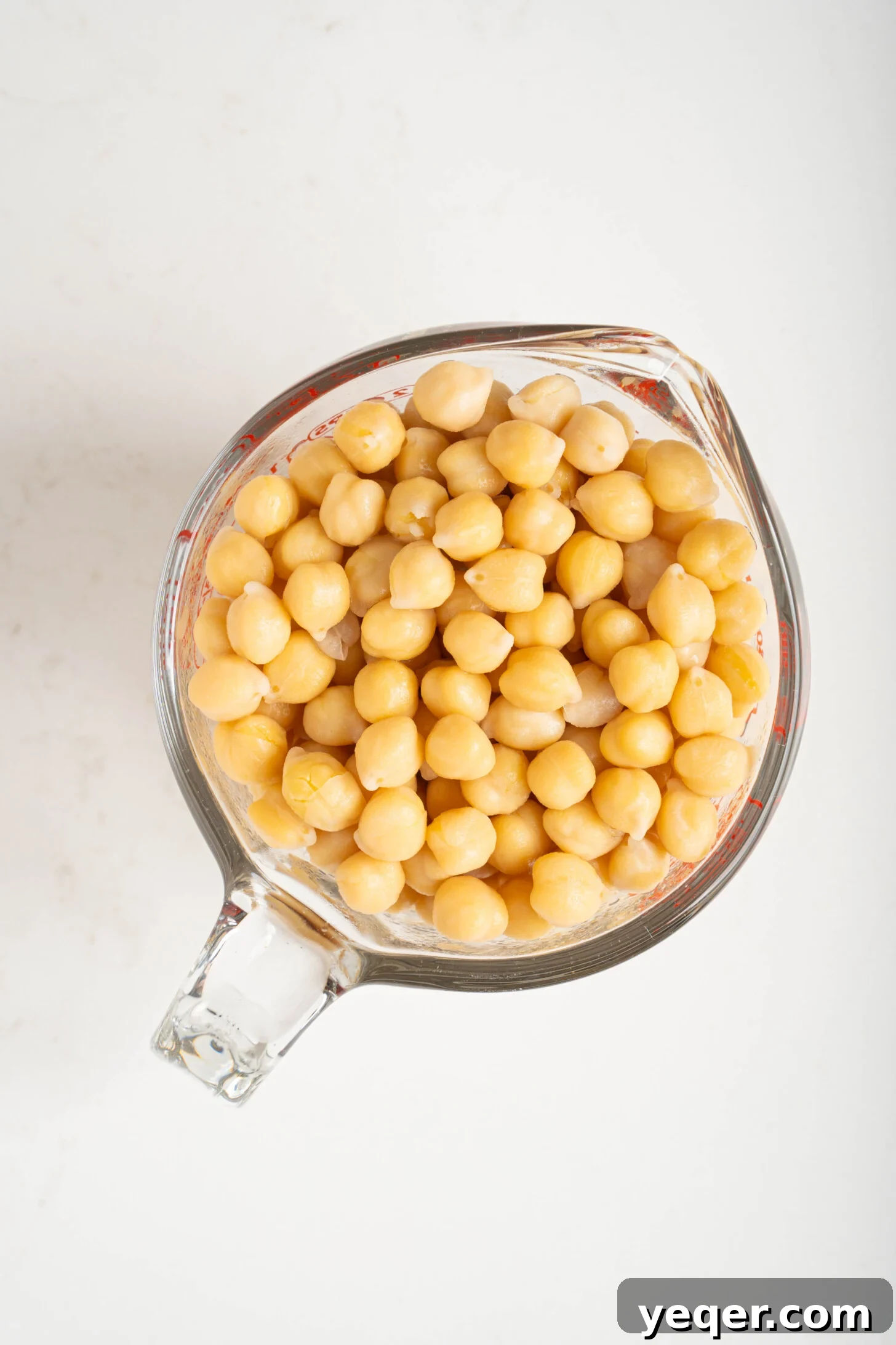 The Foolproof Soak and Boil Method for Perfect Dried Chickpeas 9 a measuring cup with chickpeas