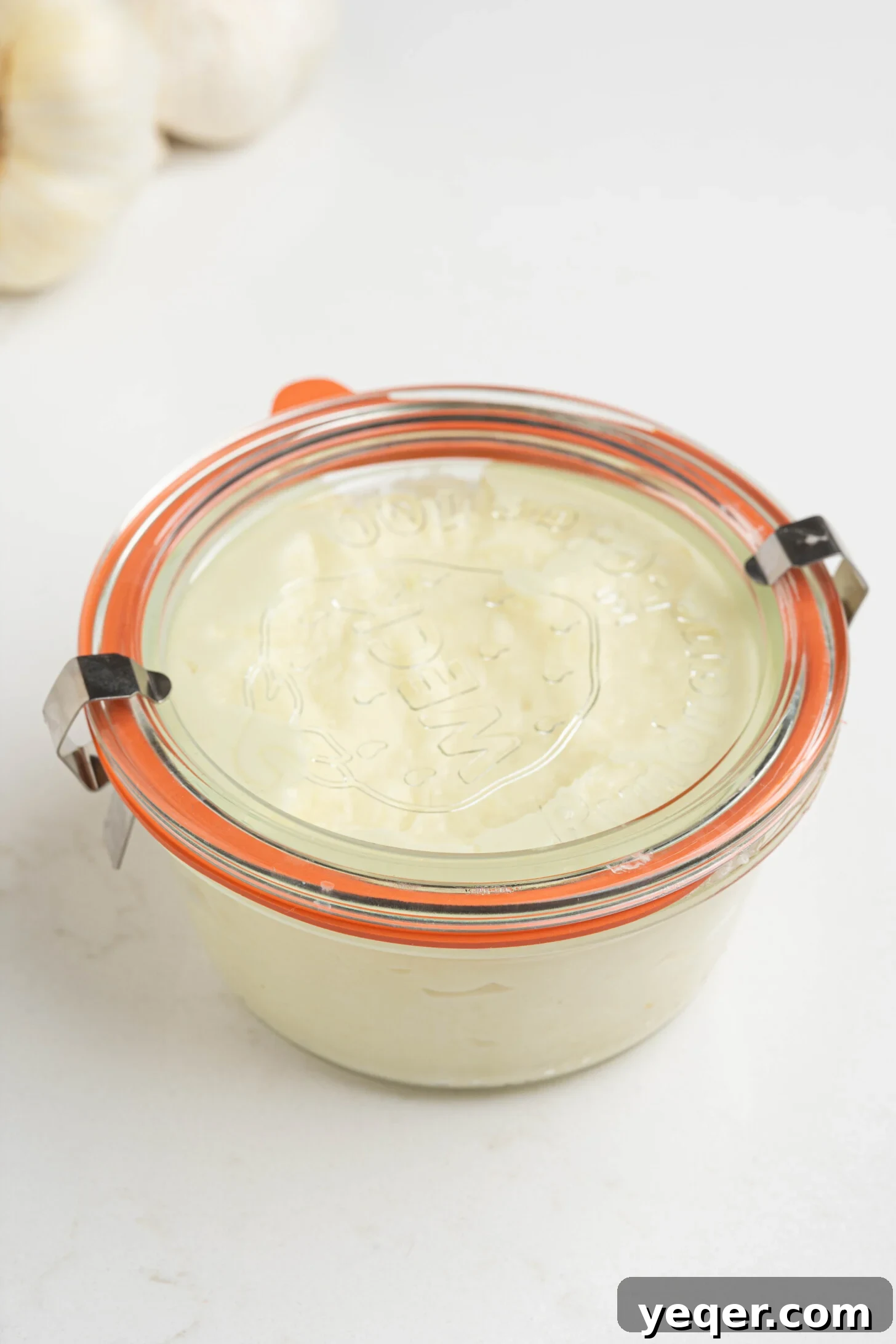 Fluffy 5-Ingredient Garlic Toum 9 a container of fluffy garlic sauce