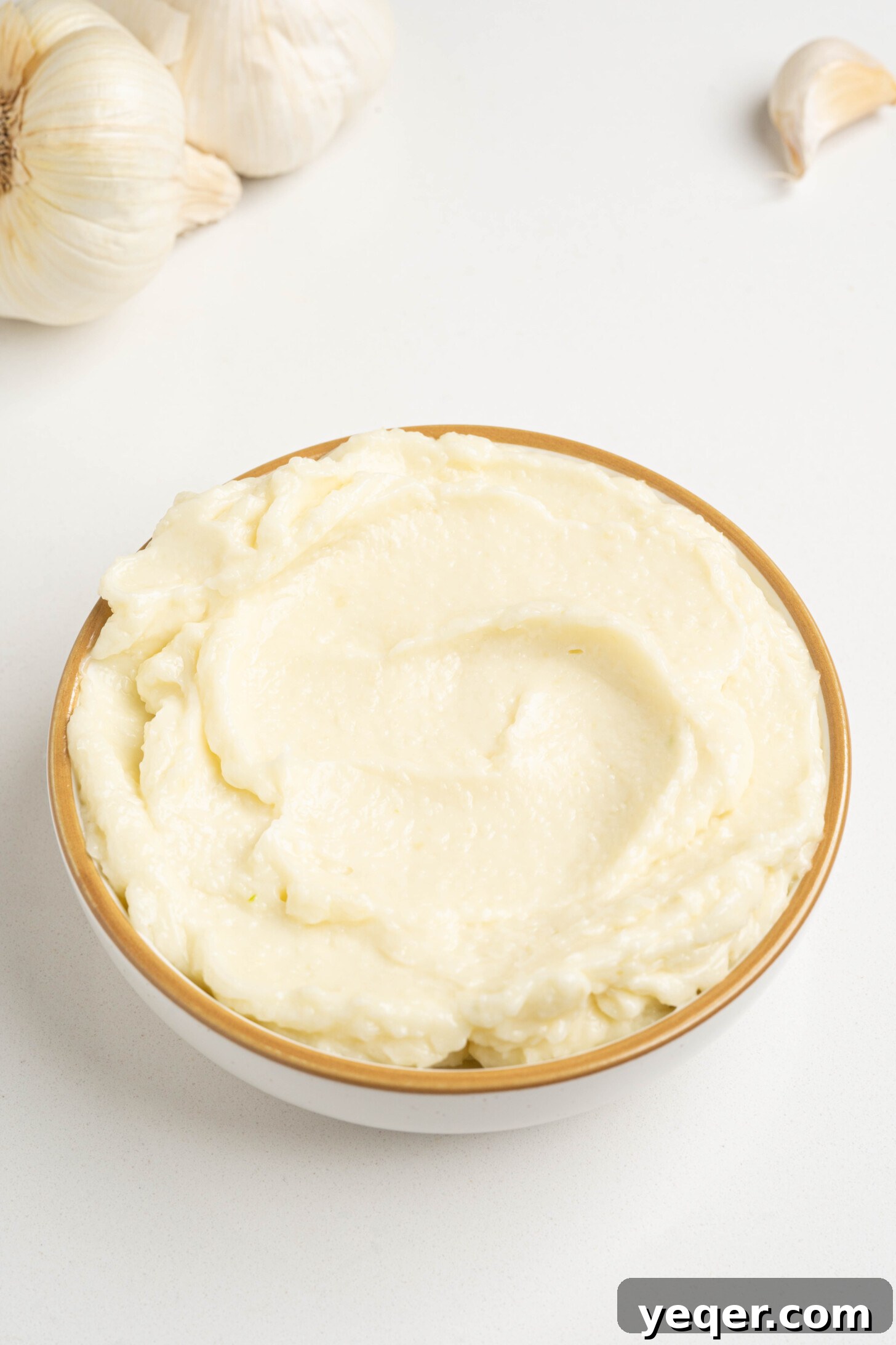 Fluffy 5-Ingredient Garlic Toum 10 a bowl of fluffy garlic sauce