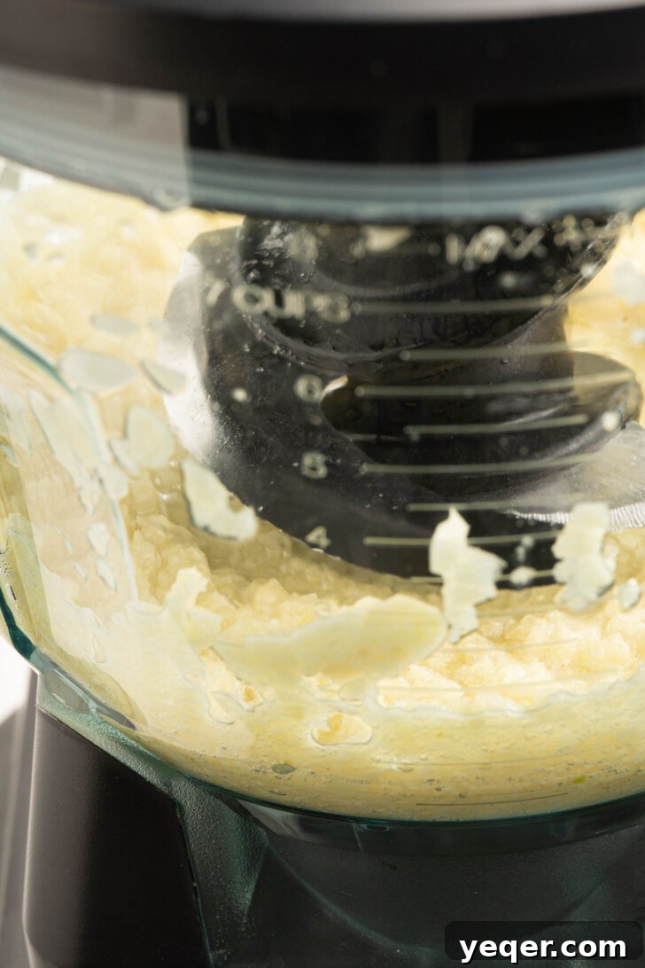 Fluffy 5-Ingredient Garlic Toum 4 a food processor with blended garlic