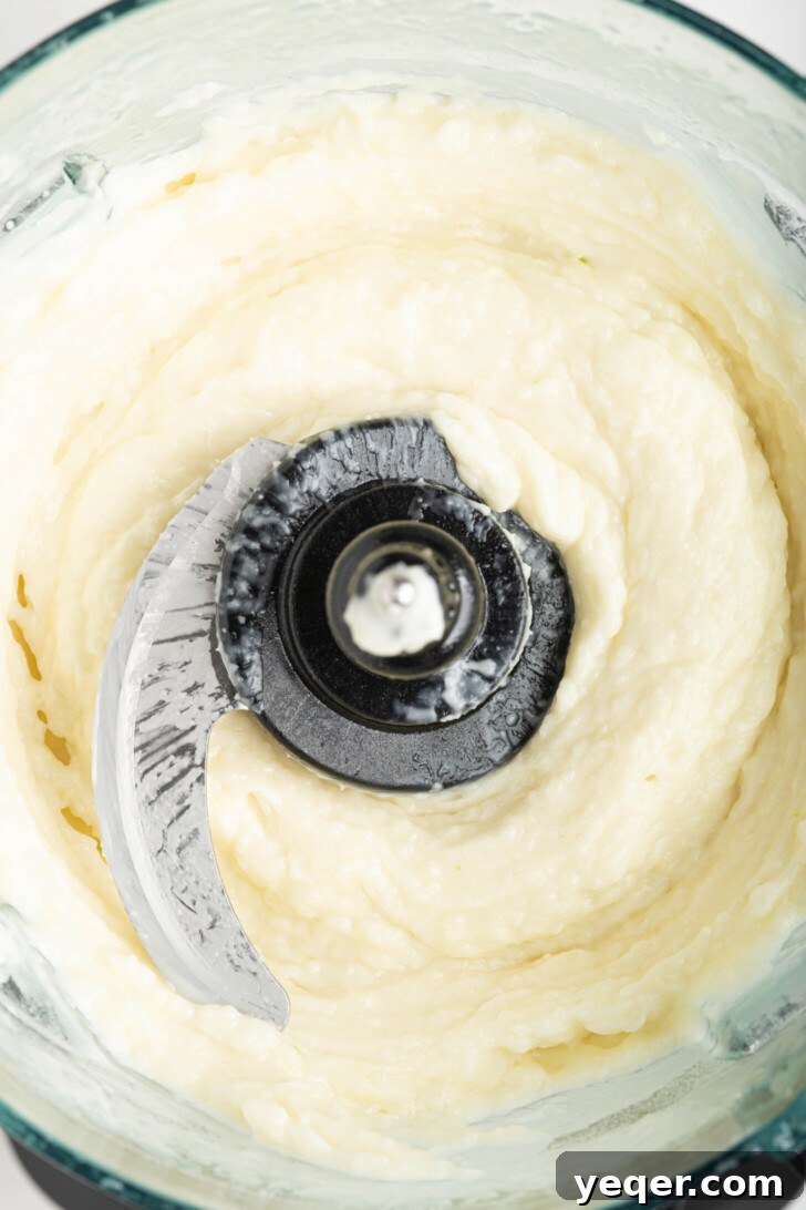 Fluffy 5-Ingredient Garlic Toum 7 a food processor with garlic sauce