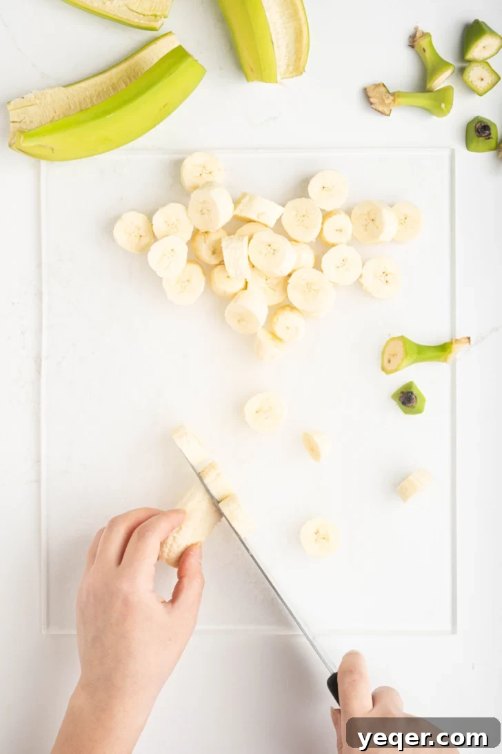Green Banana Escabeche 5 sliced bananas on a cutting board
