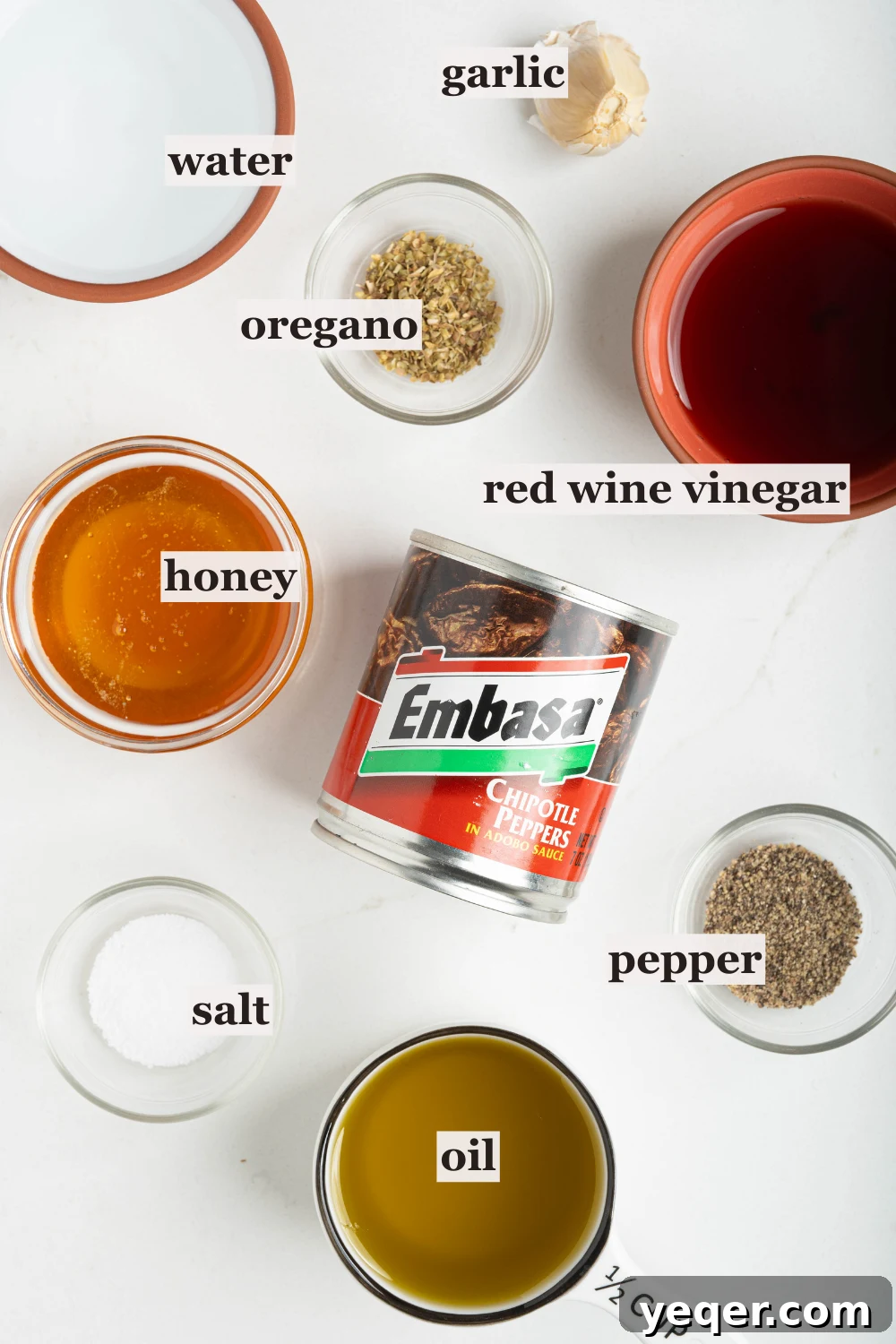 Effortless Chipotle Vinaigrette 4 Ingredients for Chipotle Vinaigrette laid out on a wooden cutting board.