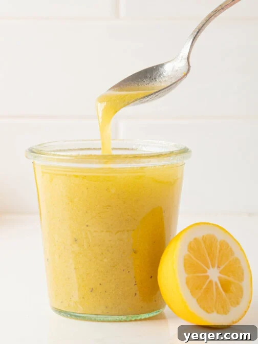 lemon vinaigrette pouring into a jar