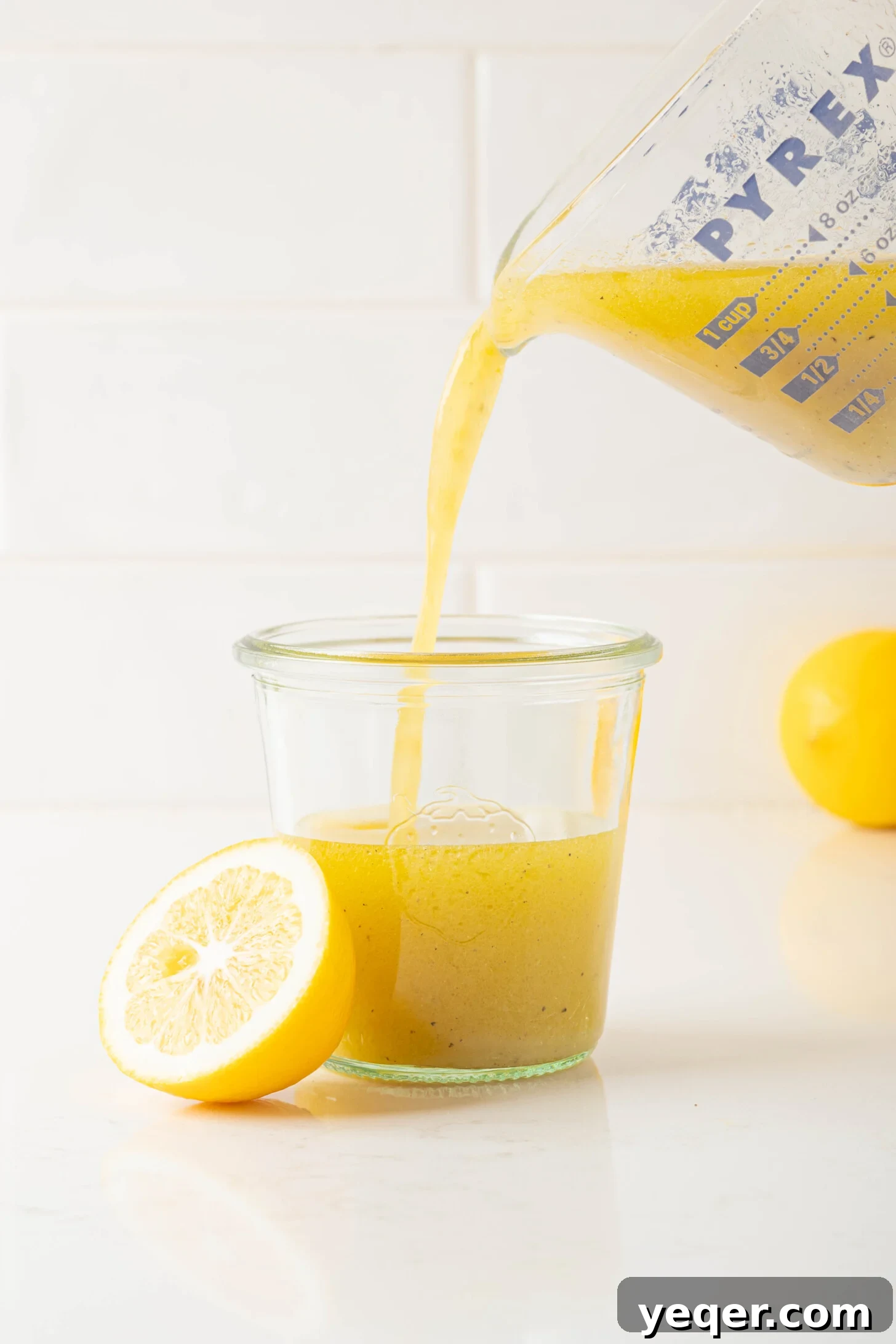 Speedy Gourmet Lemon Vinaigrette 6 lemon vinaigrette pouring into a jar