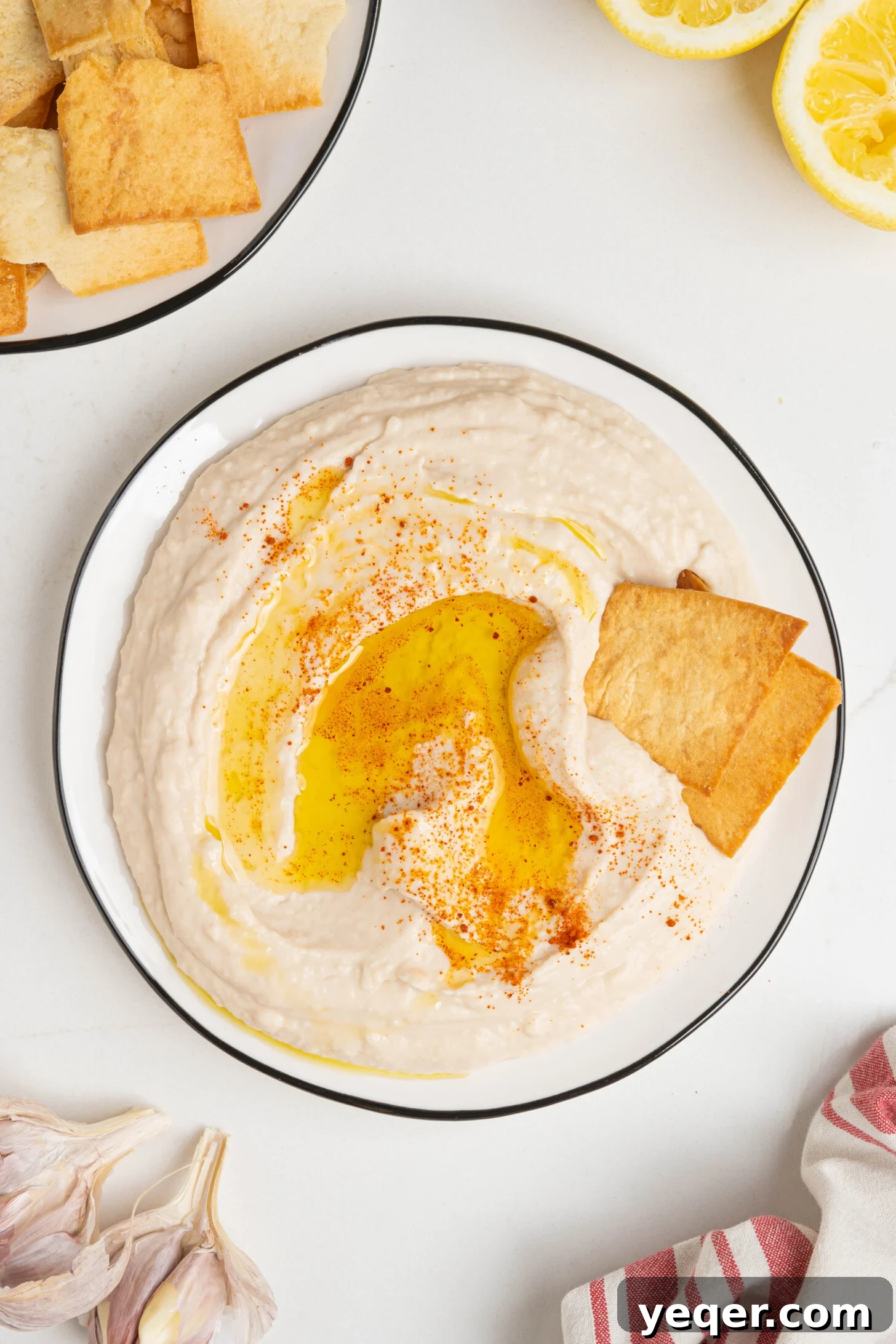 A beautifully garnished plate of white bean hummus, ready for serving.