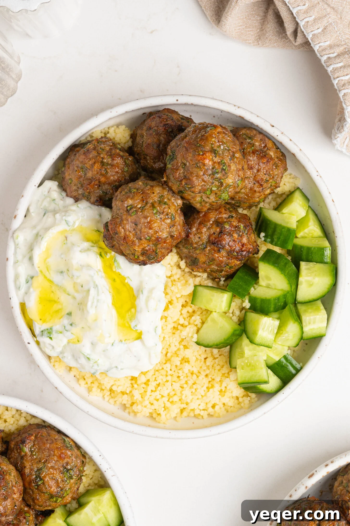Moroccan Spiced Baked Lamb Meatballs 3 A bowl of couscous, lamb meatballs, and more.