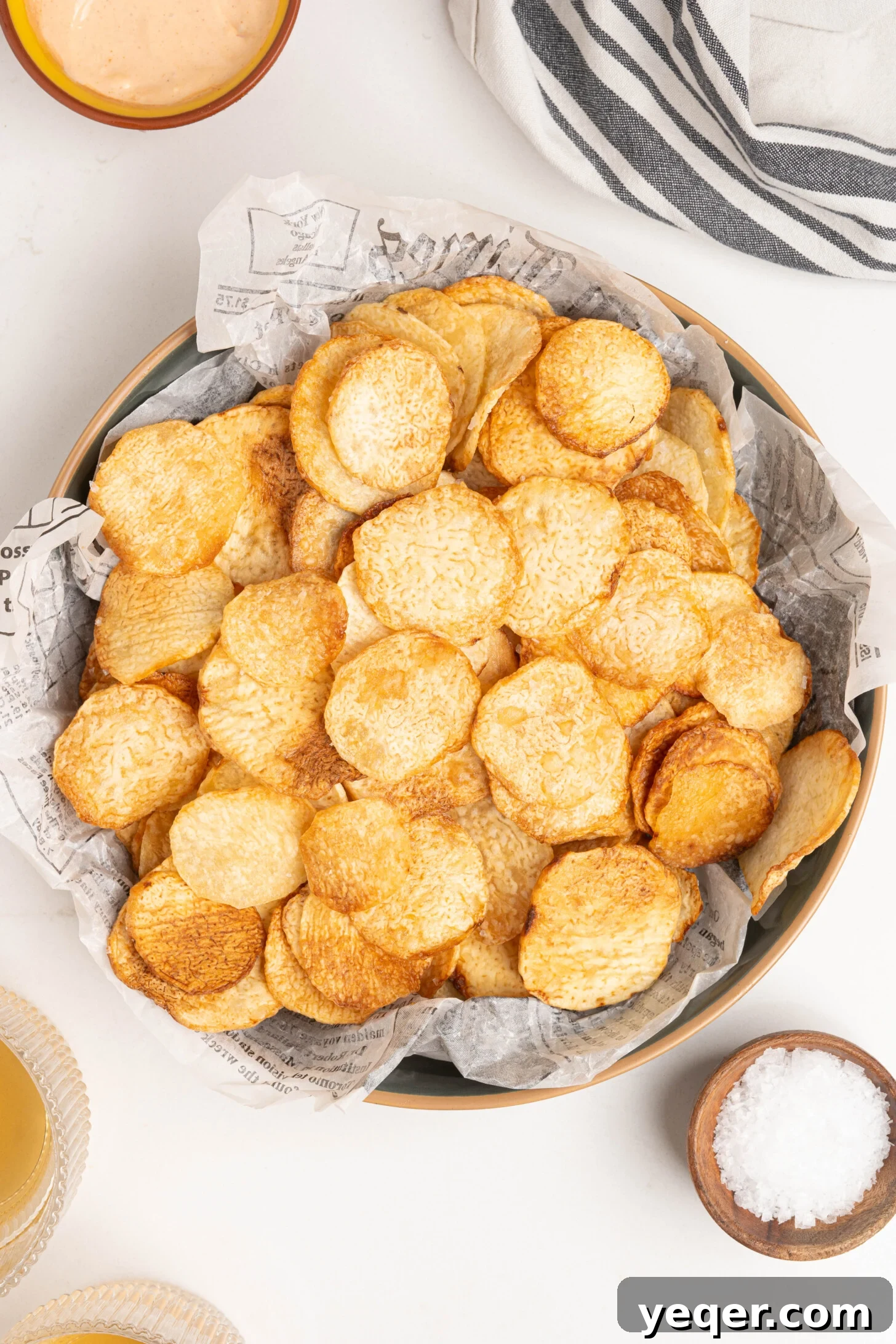 Crispy Taro Chips 30 Minutes Oven and Air Fryer 8 A close-up of a bowl filled with perfectly golden and crispy deep-fried taro chips, ready for snacking.