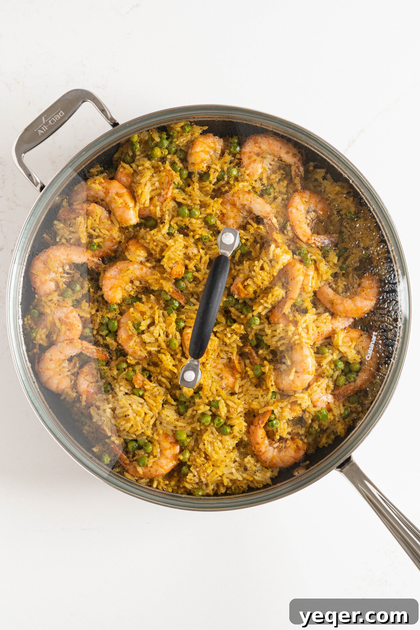 Vibrant Puerto Rican Arroz con Camarones 11 A wide shot of Arroz con Camarones in a large cooking pan, showcasing its rich color and texture.