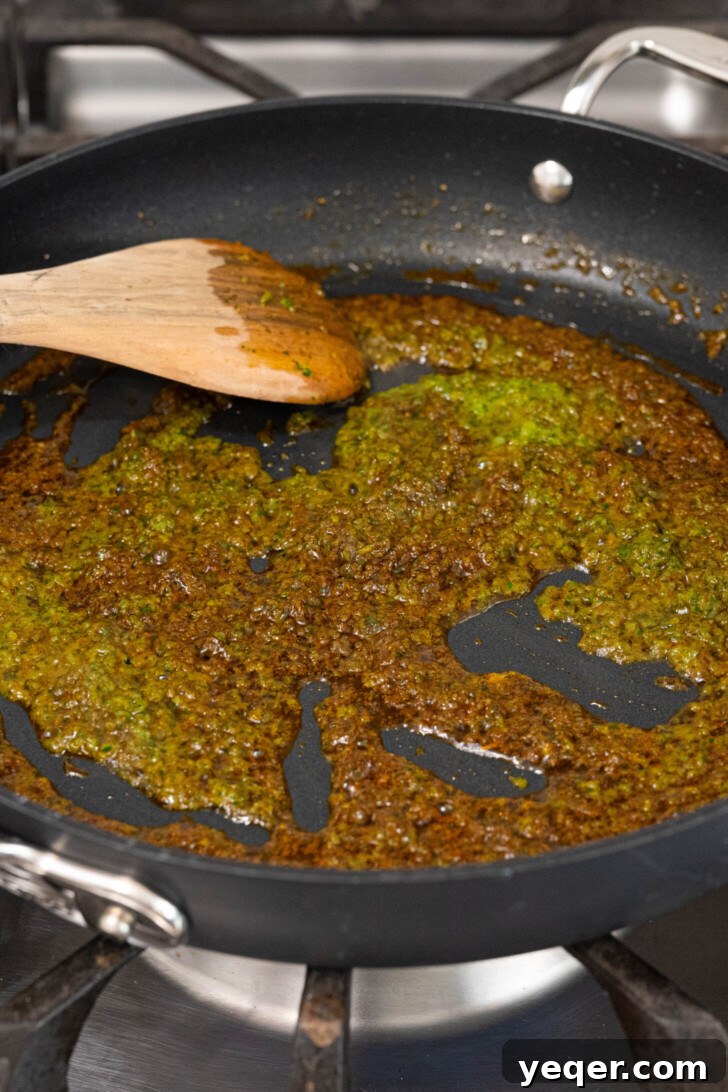 Vibrant Puerto Rican Arroz con Camarones 4 A pan with sofrito and achiote oil shimmering over medium heat.