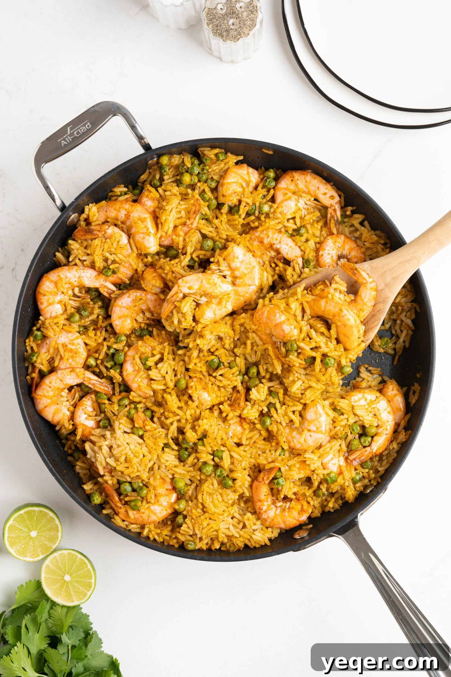 Vibrant Puerto Rican Arroz con Camarones 9 A pan filled with fluffy red rice and perfectly cooked shrimp, ready to be served.