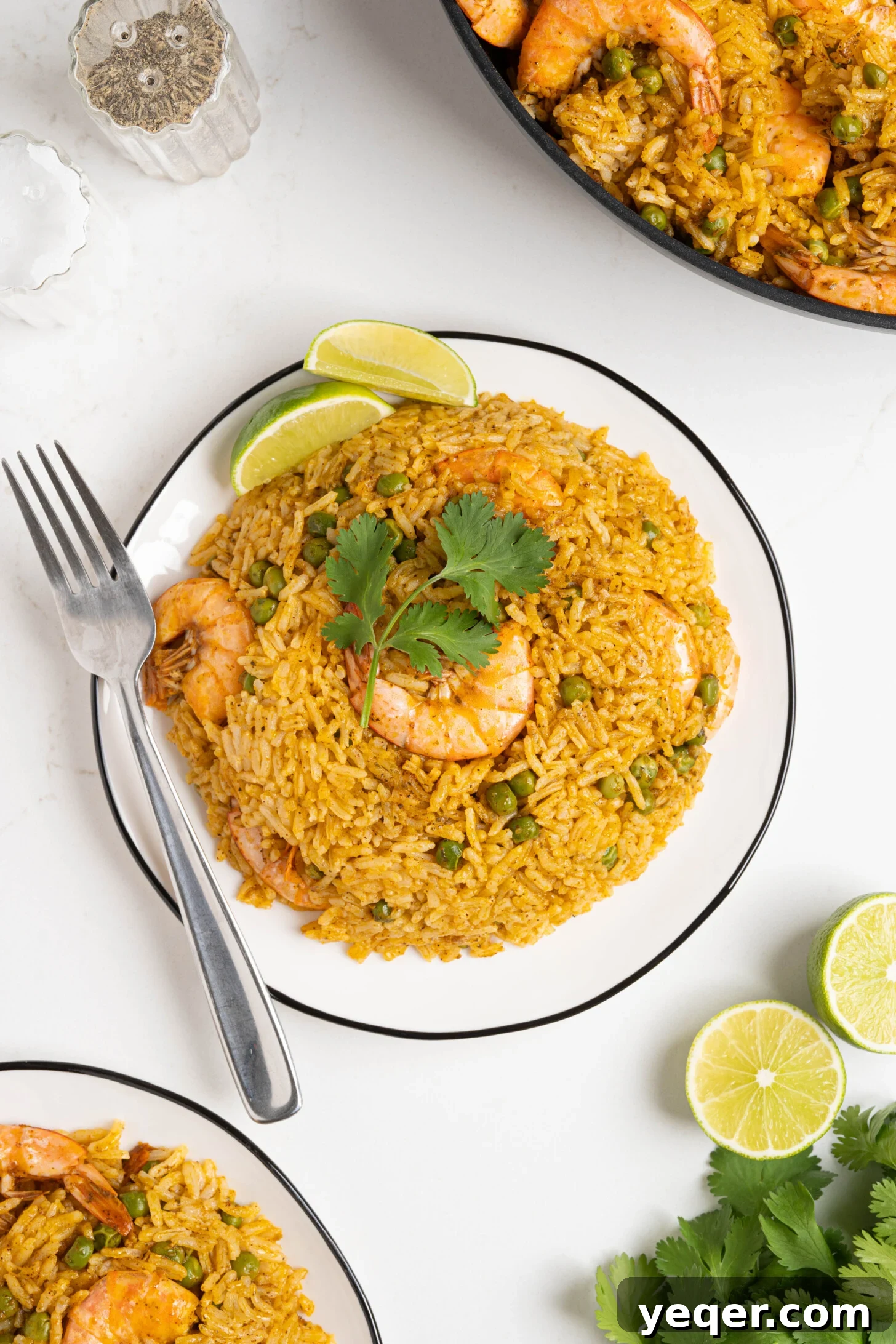 Vibrant Puerto Rican Arroz con Camarones 10 A close-up shot of a plate of Arroz con Camarones, garnished with fresh cilantro and a lime wedge.