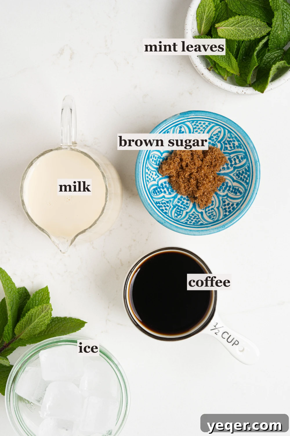 Easy Philz Style 5 Ingredient Coffee Mint Mojito 3 Individual bowls of fresh mint, brown sugar, milk, coffee, and ice, ready for preparation.
