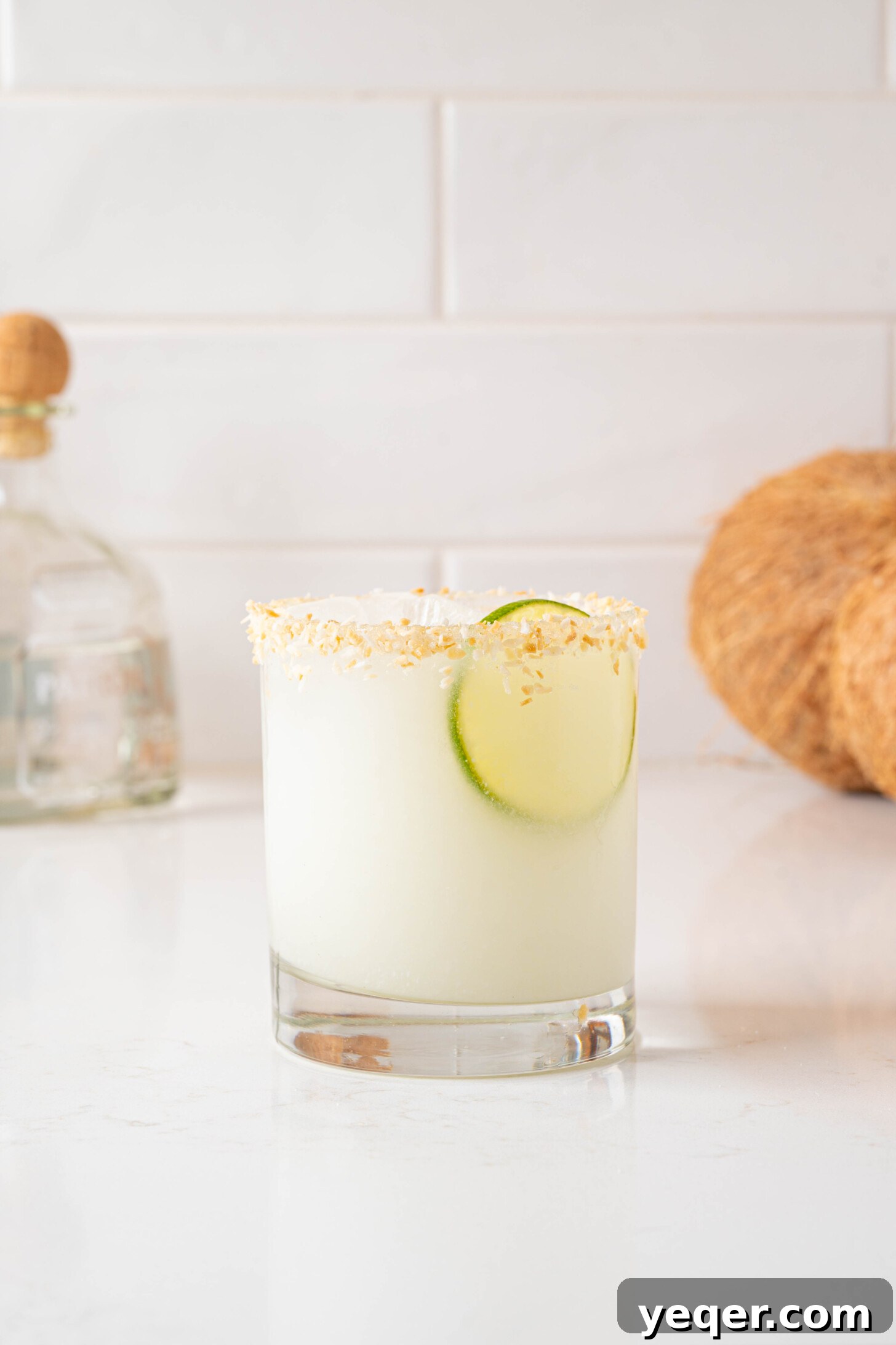Effortless Silky Coconut Margarita 2 A beautifully garnished coconut margarita in a glass, ready to be enjoyed.