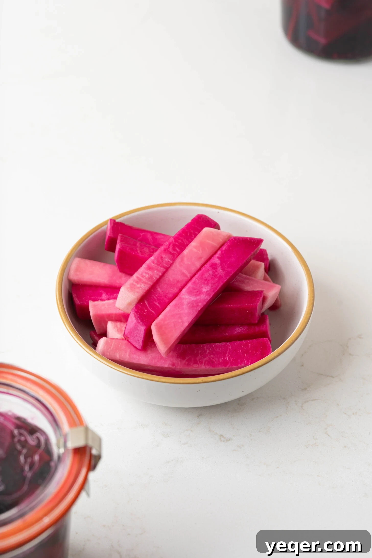 Easy 5-Ingredient Pink Pickled Turnips 12 A vibrant and appetizing bowl of pink pickled turnips, ready for serving or garnishing.