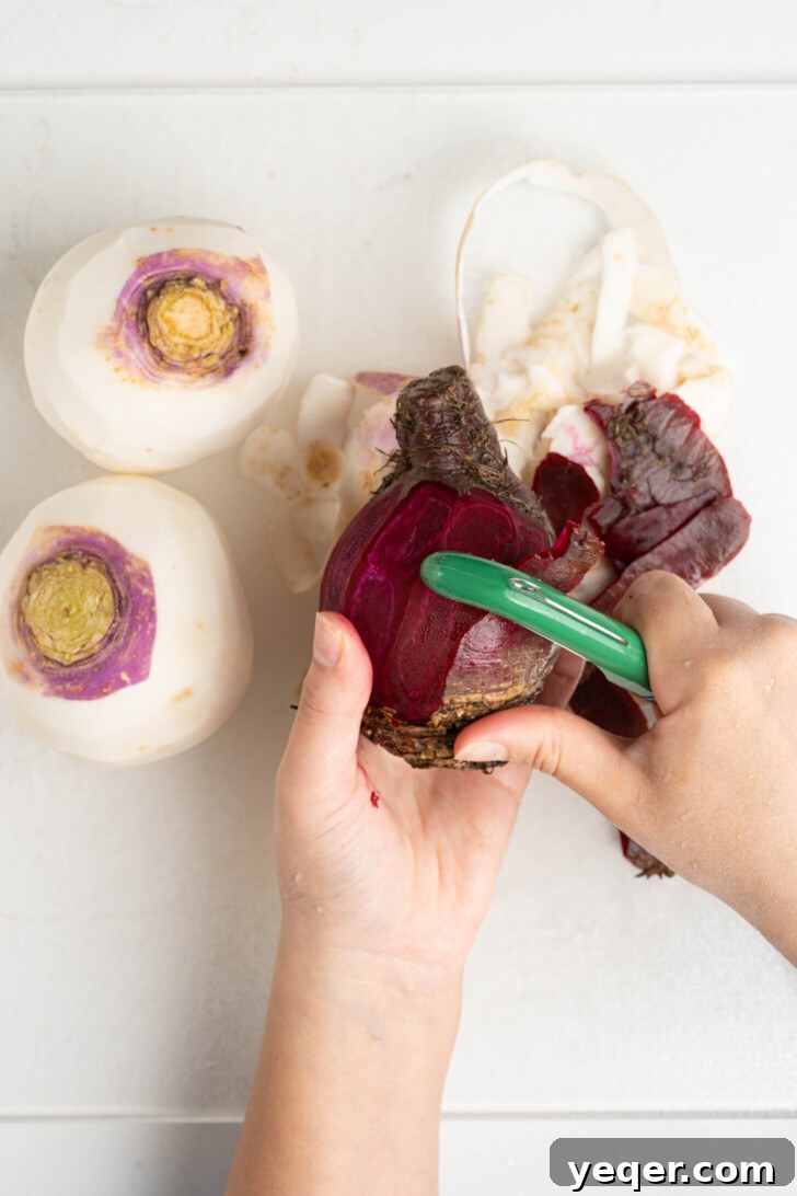 Easy 5-Ingredient Pink Pickled Turnips 5 A hand peeling a beet, preparing it for the pickling process.