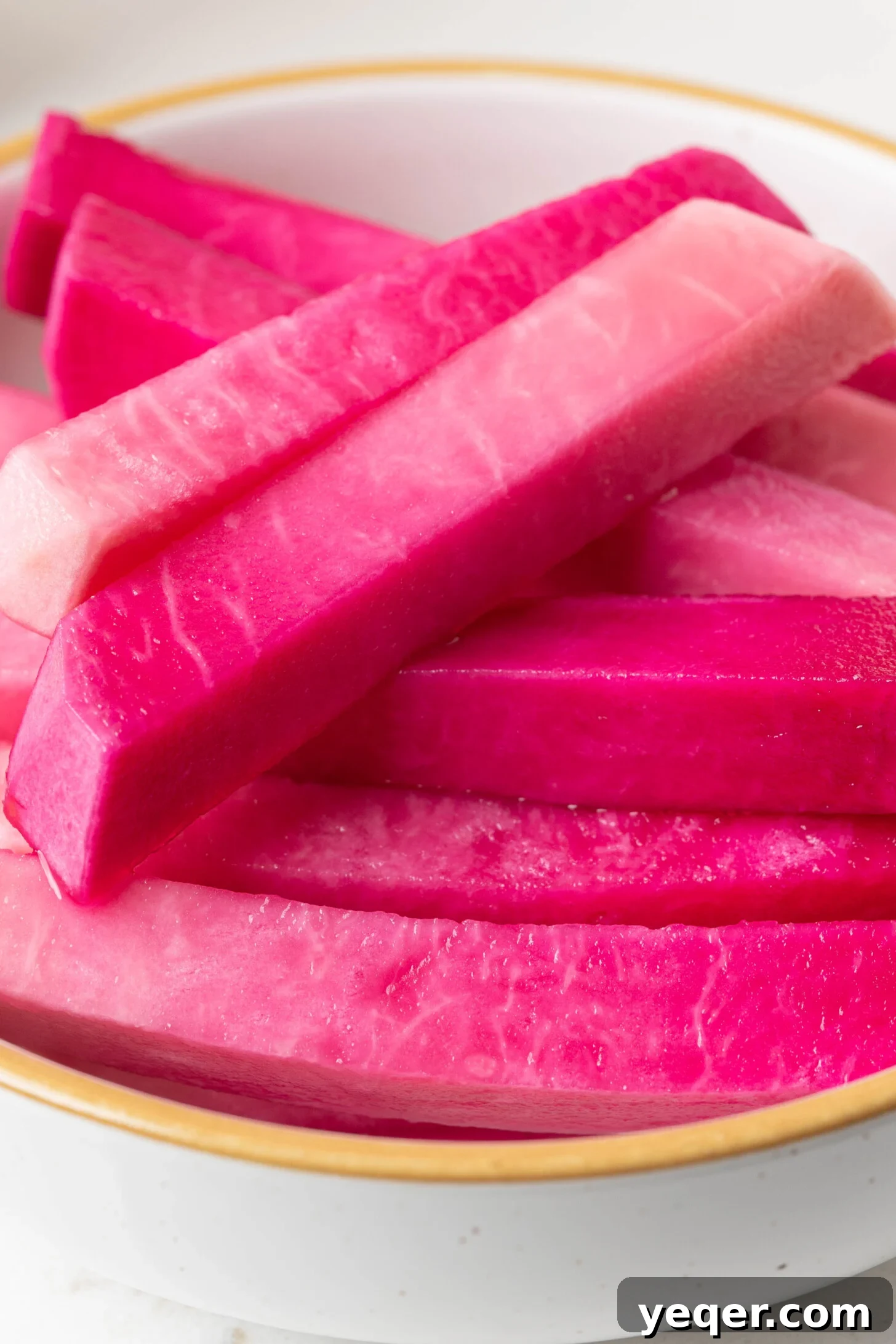 Easy 5-Ingredient Pink Pickled Turnips 9 A close-up shot of a bowl of pink pickled turnips, showcasing their vibrant color and readiness for serving.
