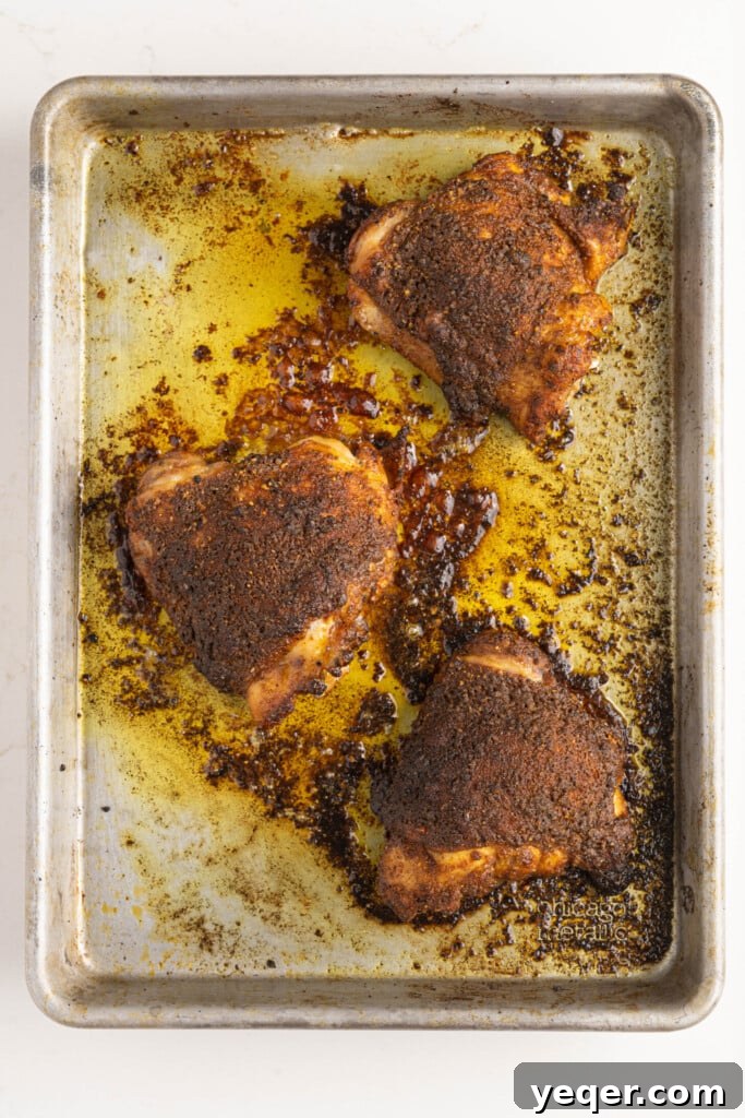 Golden Roast Chicken & Bean Feast 4 Seasoned chicken thighs arranged on a baking pan, ready for roasting.