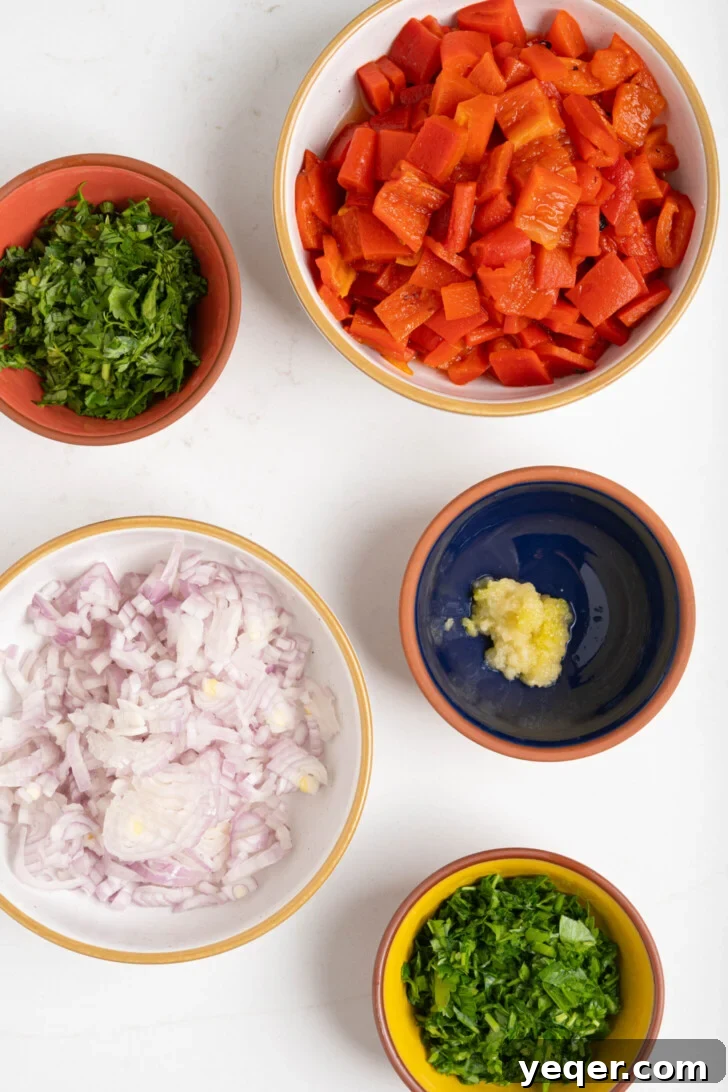 Golden Roast Chicken & Bean Feast 5 Small bowls containing finely minced fresh cilantro, parsley, diced shallots, and roasted red peppers.