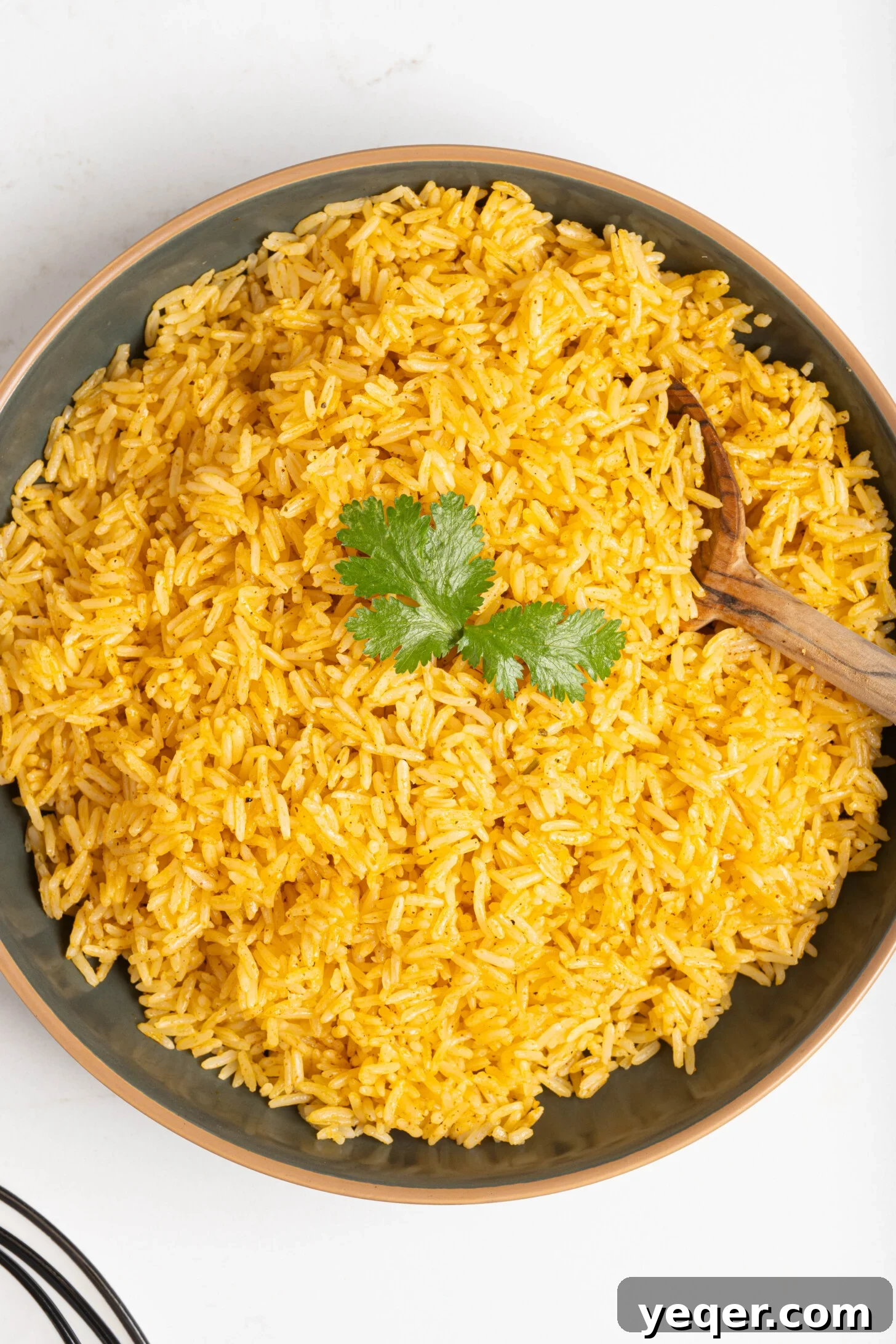Fluffy 30-Minute Yellow Rice 11 A close-up shot of a full pot of freshly cooked Arroz Amarillo, ready to be served.