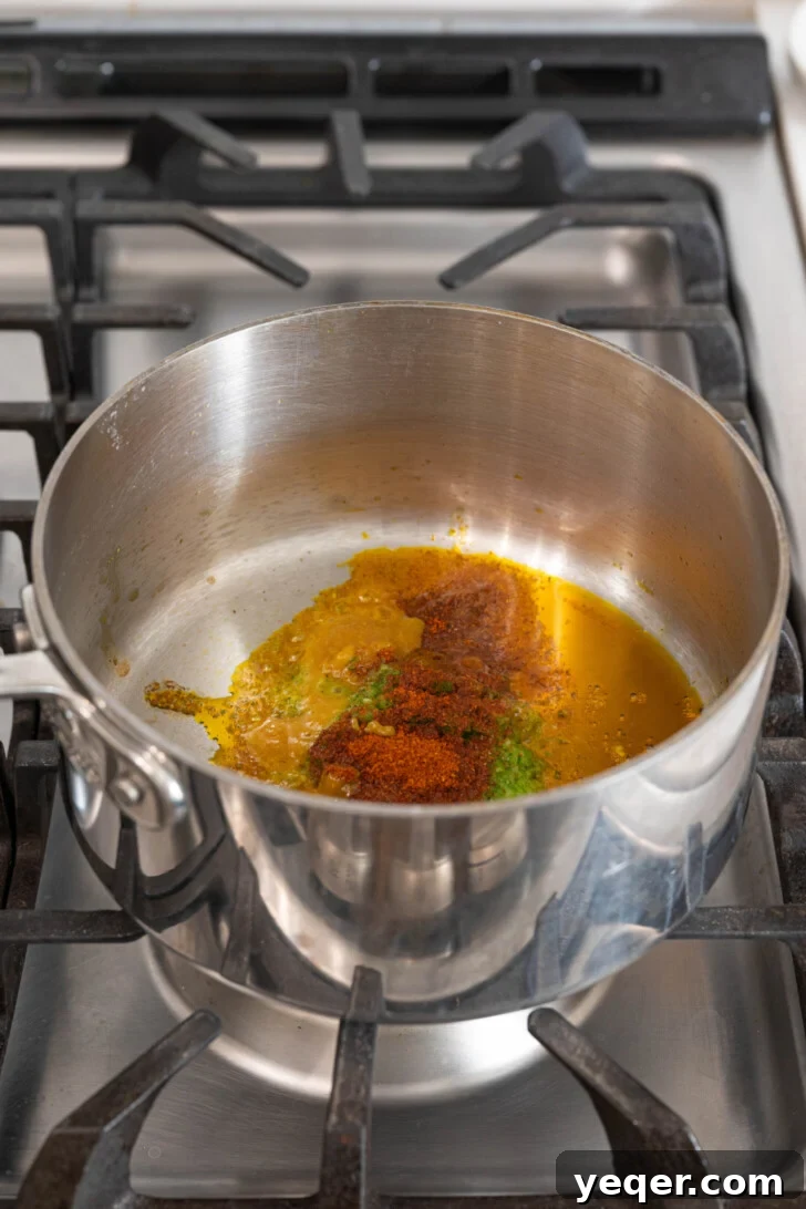 Fluffy 30-Minute Yellow Rice 5 Sofrito and spices simmering in a medium-sized pot.