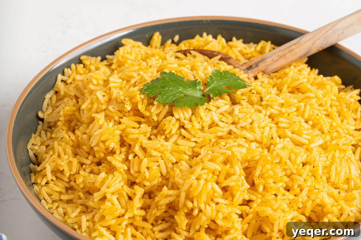 Fluffy 30-Minute Yellow Rice 9 A vibrant bowl of Arroz Amarillo, showcasing its golden color and fluffy texture.