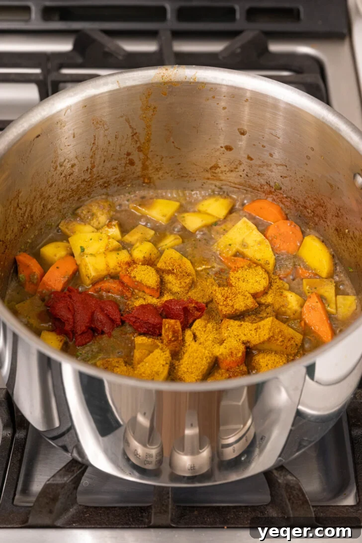 Carne Guisada The Ultimate Beef Stew 7 Spices and tomato paste with veggies in a pot.