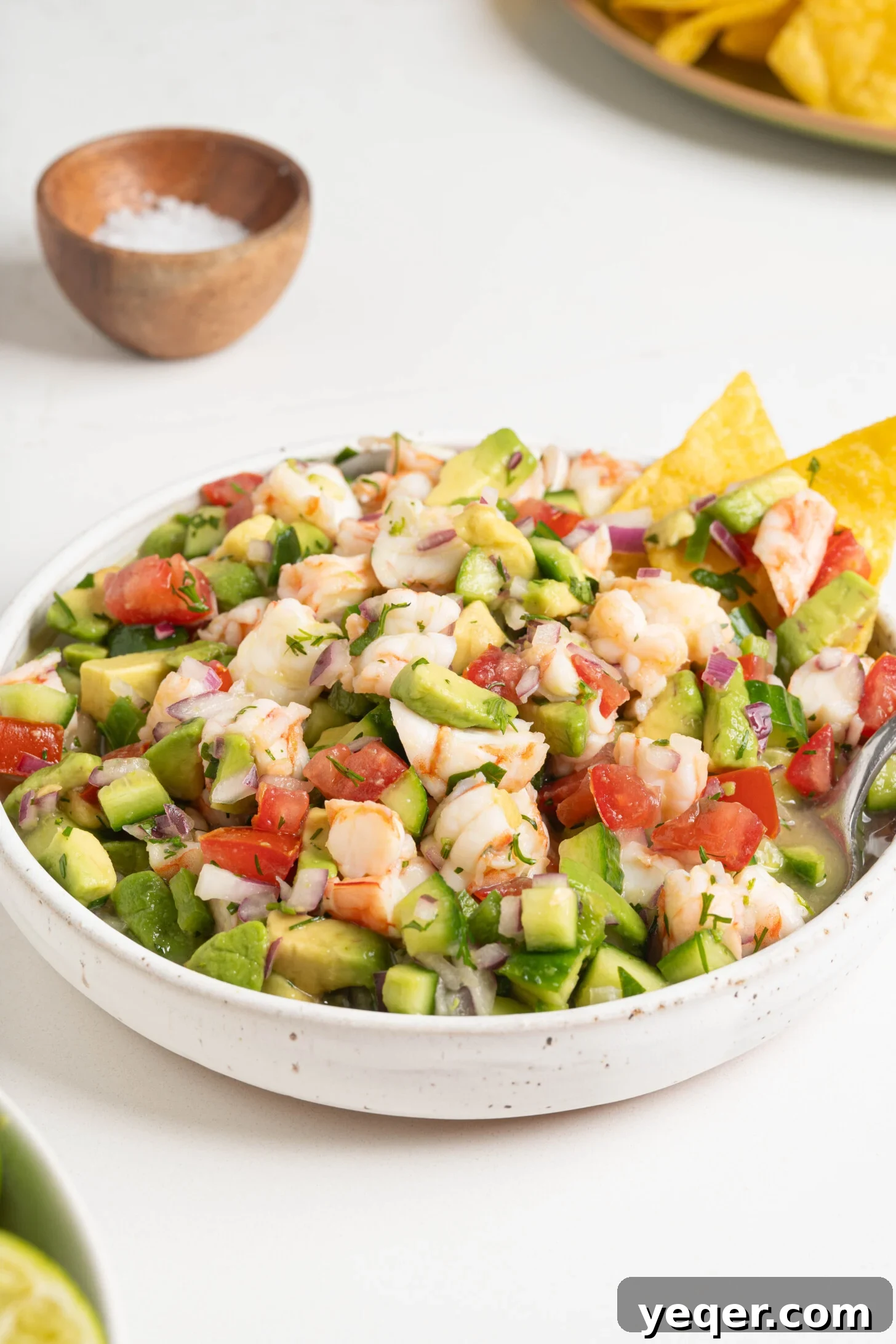 Fresh and Zesty Shrimp Ceviche 10 Shrimp ceviche in a serving bowl with a spoon.