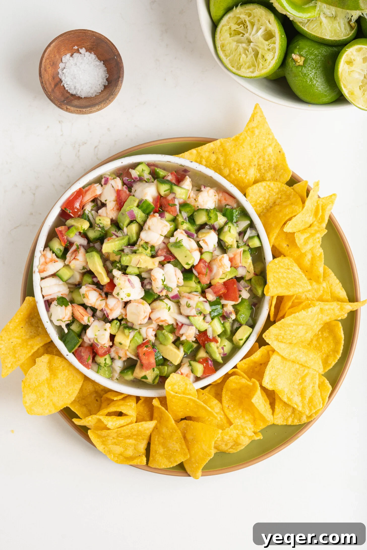 Fresh and Zesty Shrimp Ceviche 11 Shrimp ceviche in a bowl with tortilla chips on the side.