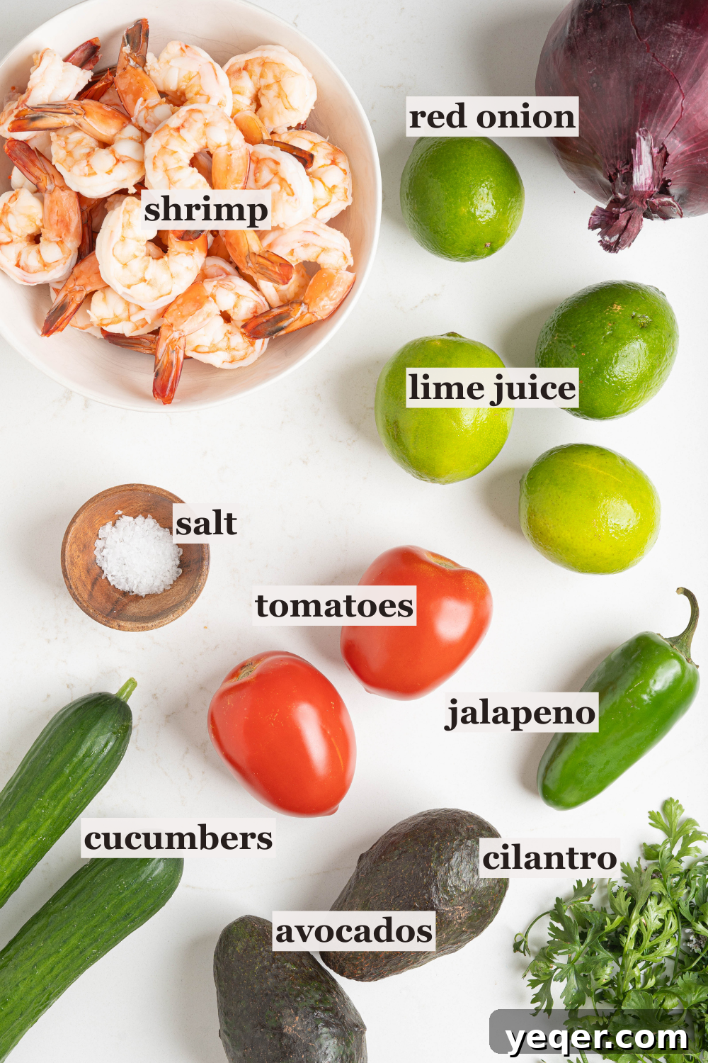 Fresh and Zesty Shrimp Ceviche 4 Limes, avocados, shrimp, and other ceviche ingredients on a table.