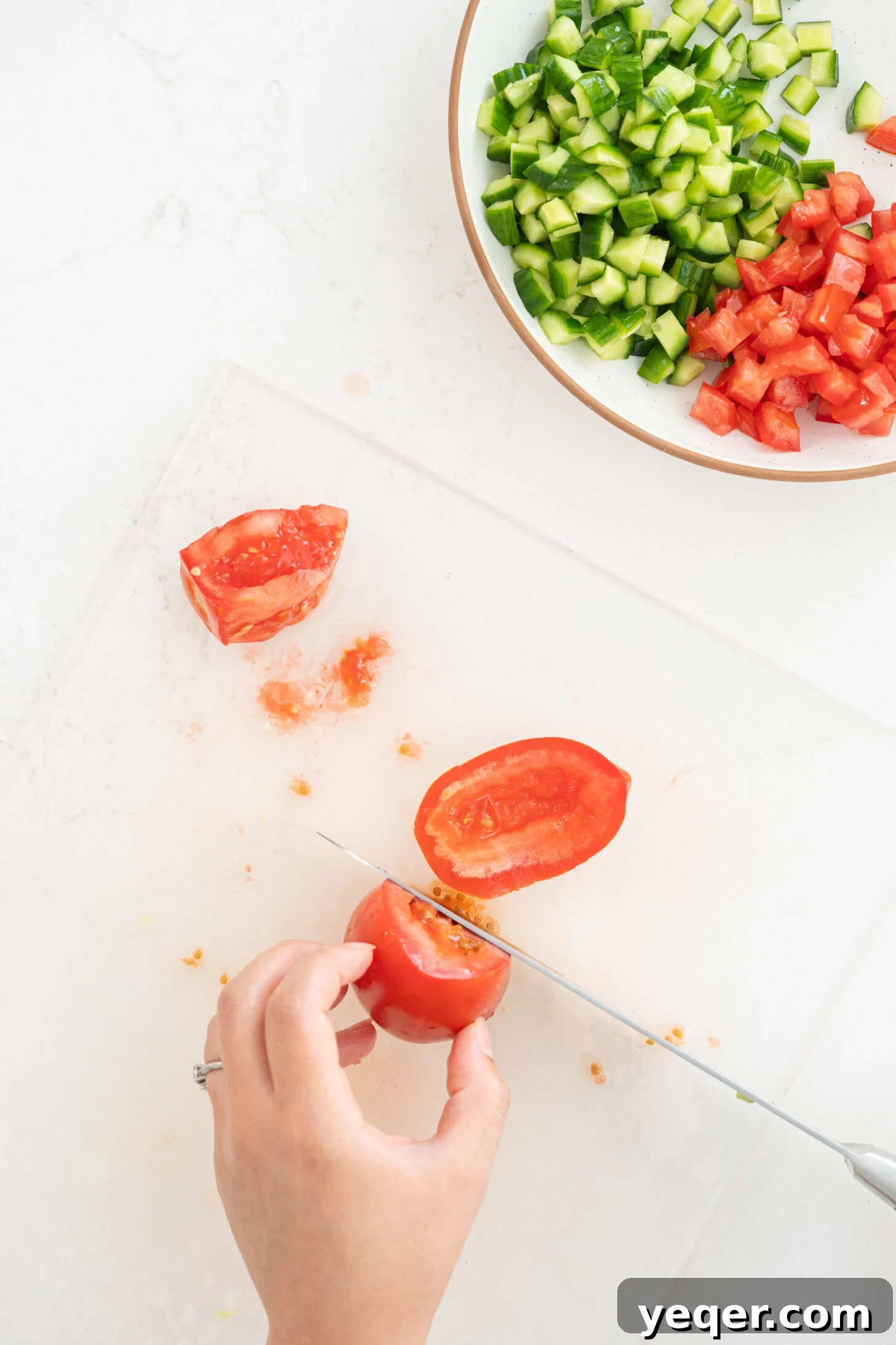 Fresh and Zesty Shrimp Ceviche 7 A tomato being sliced on a cutting board.