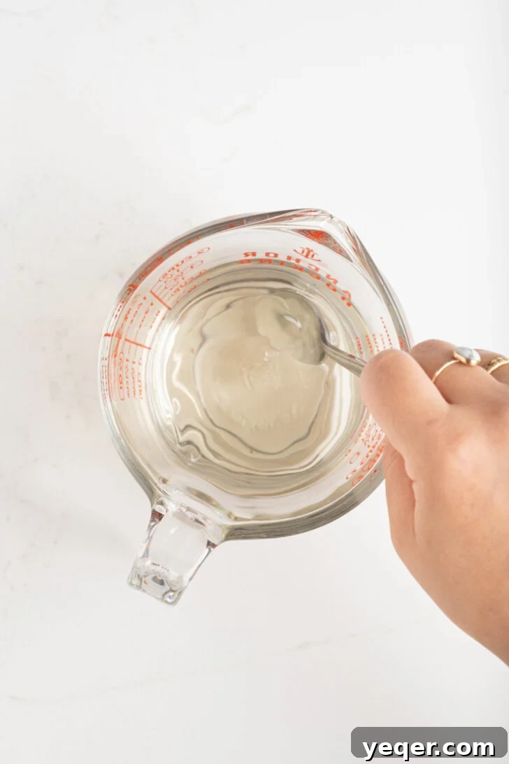 Mediterranean Breeze Mint Lemonade 4 Simple syrup being mixed in a bowl, showing sugar dissolving in hot water.