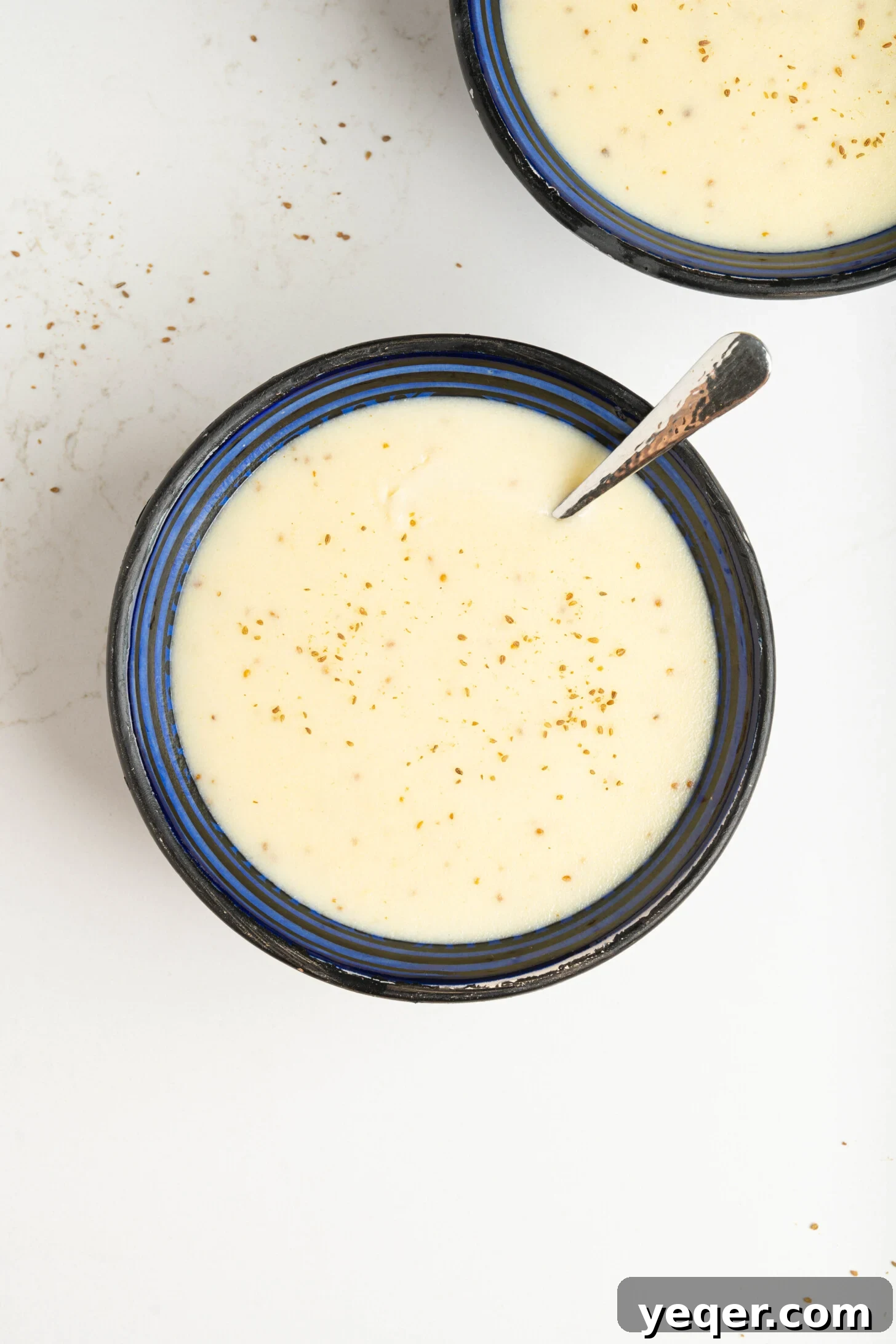 Baba's Moroccan Semolina Cold Remedy 2 A comforting bowl of Moroccan semolina soup, garnished with a sprinkle of anise seeds, ready to be enjoyed.