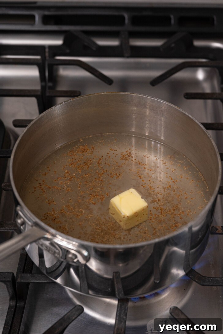Baba's Moroccan Semolina Cold Remedy 4 Water, half of the ground anise seeds, salt, and butter simmering gently in a sturdy pot, creating a fragrant base for the soup.