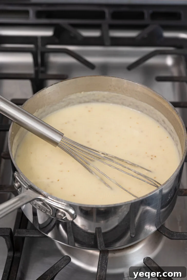 Baba's Moroccan Semolina Cold Remedy 7 A pot of freshly made Moroccan semolina soup, its surface shimmering with creamy goodness, ready to be ladled into serving bowls.