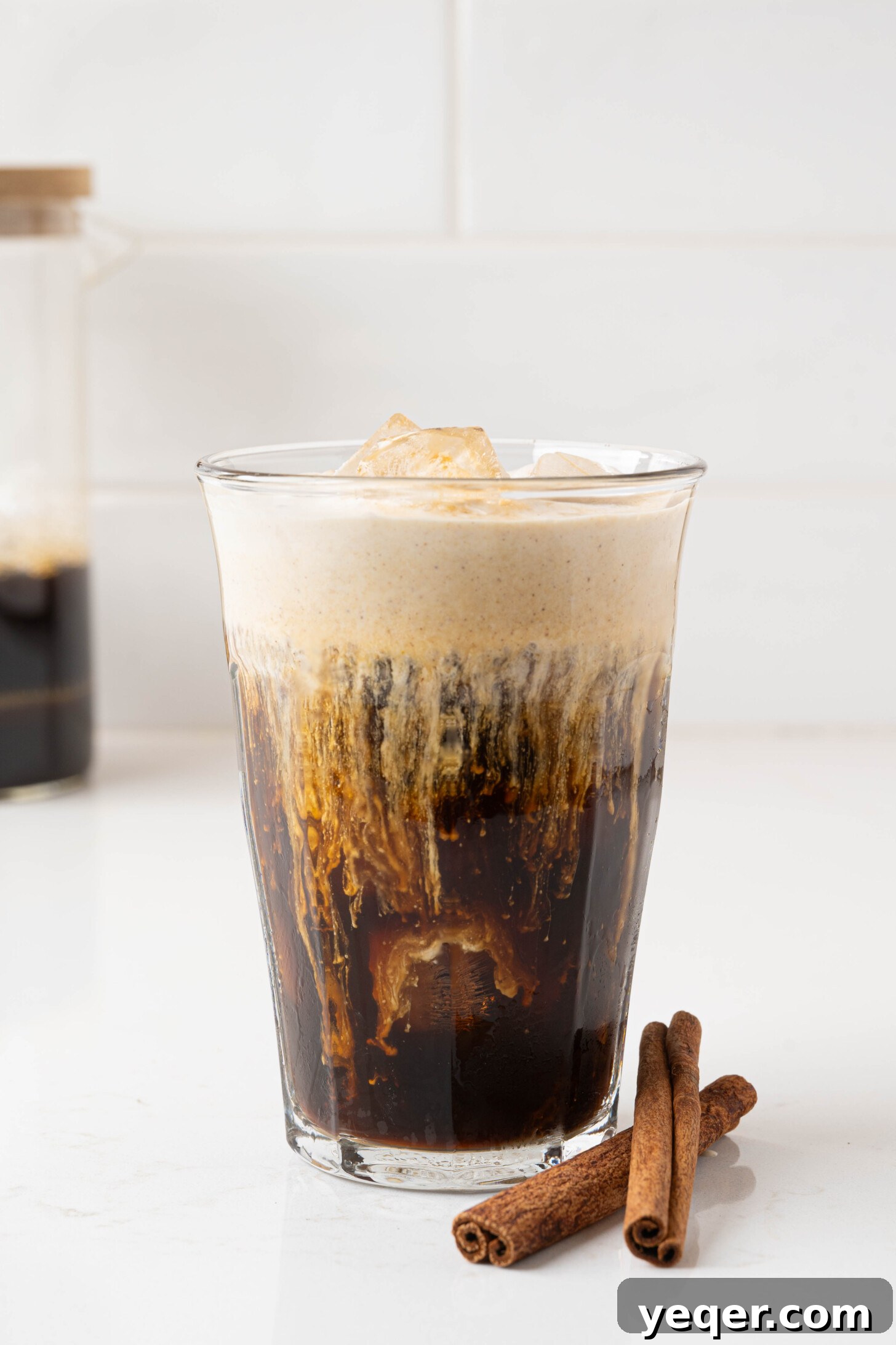 Homemade Five-Ingredient Pumpkin Spice Cold Foam 10 Pumpkin cold foam in a glass with a spoon, ready to be enjoyed.