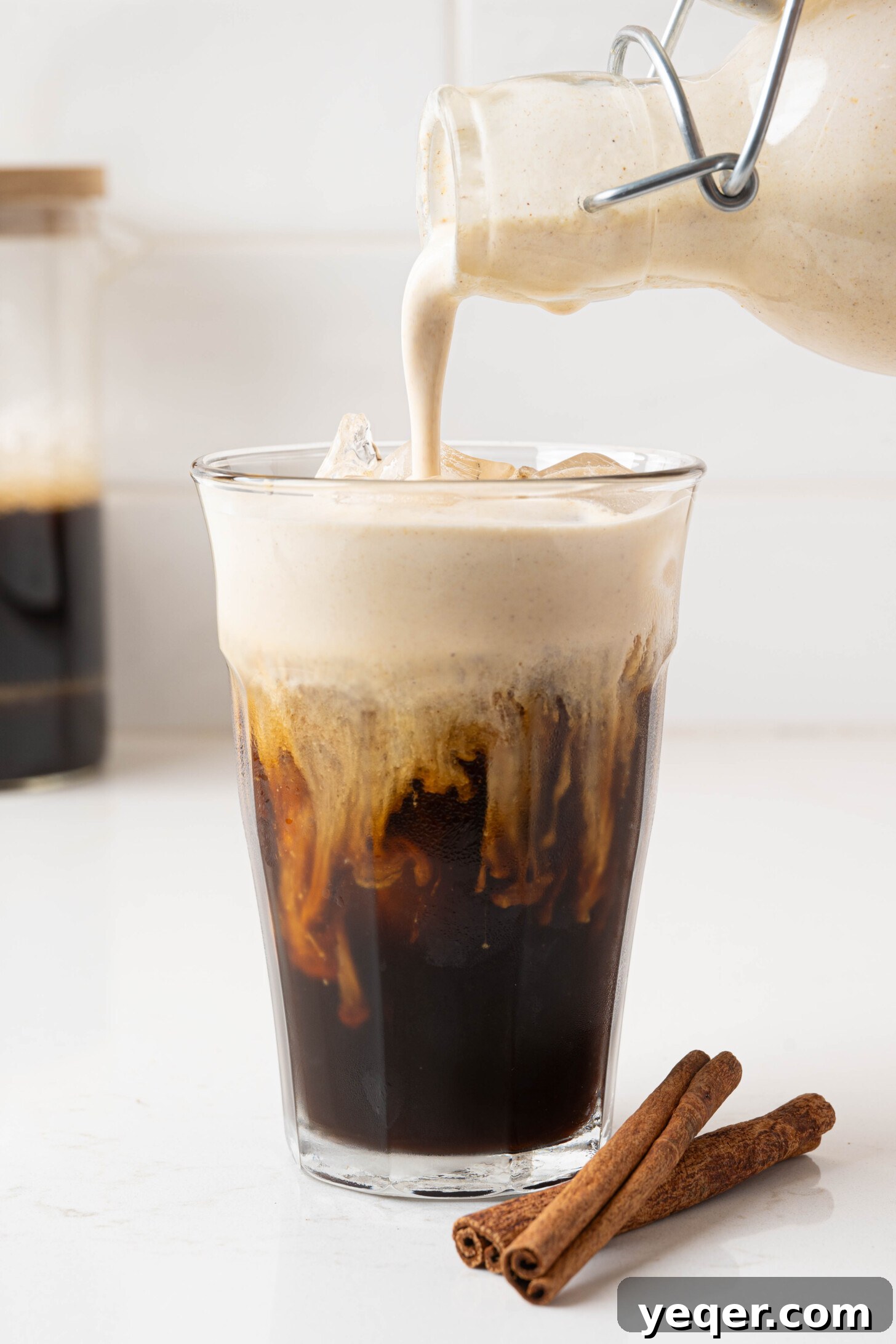 Homemade Five-Ingredient Pumpkin Spice Cold Foam 3 Pumpkin cold foam pouring over cold brew.