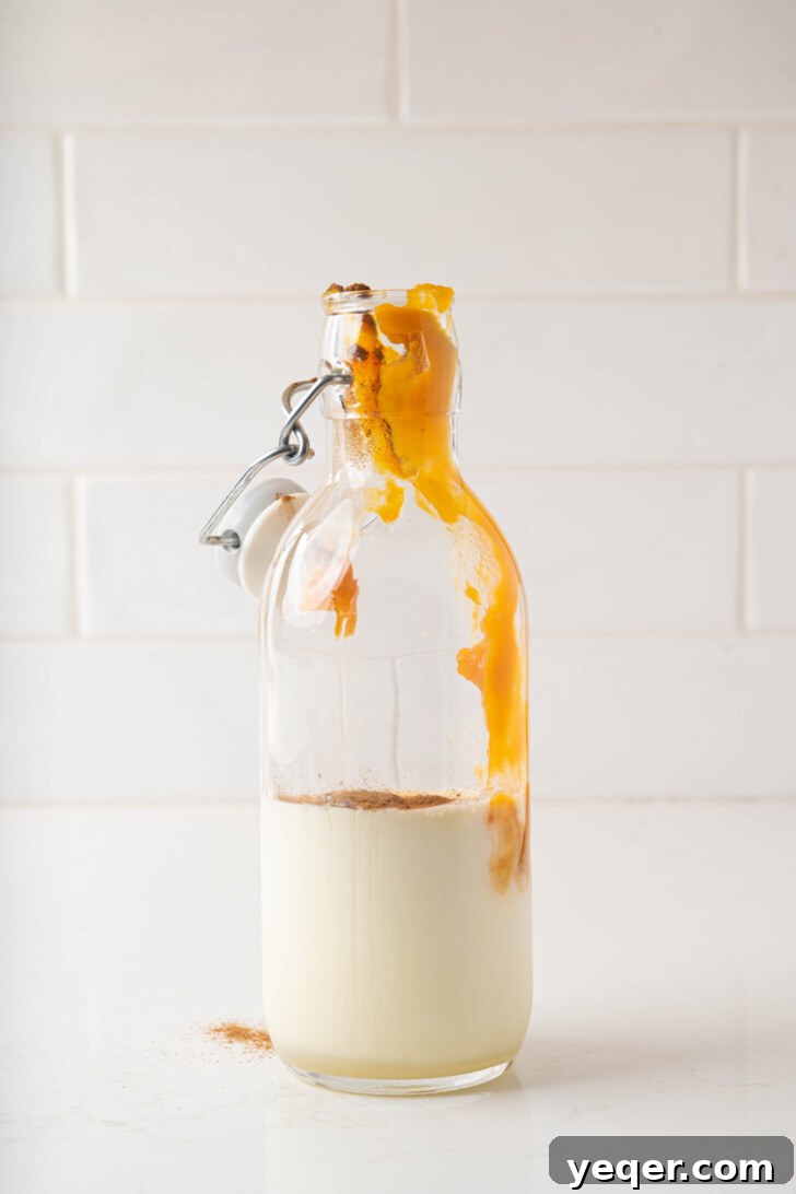 Homemade Five-Ingredient Pumpkin Spice Cold Foam 5 A bottle with pumpkin puree, milk, cream, and cinnamon.
