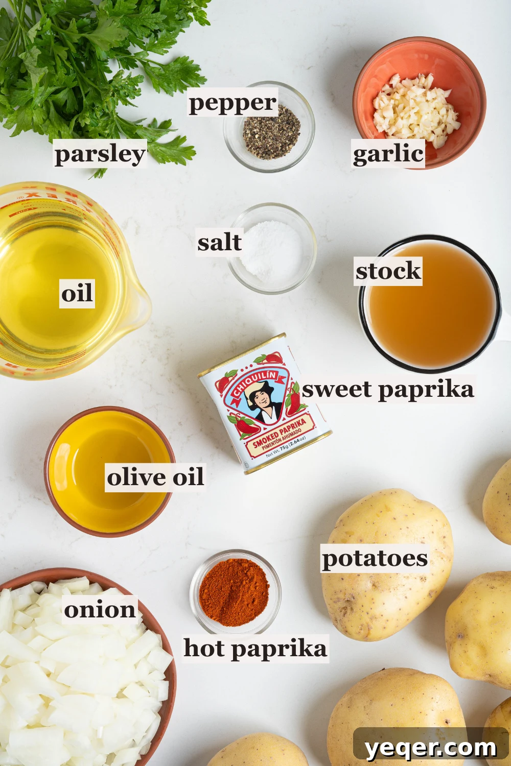 Fiery Spanish Patatas Bravas 3 Bowls of ingredients for Patatas Bravas, including chicken stock, oil, minced garlic, and various spices.