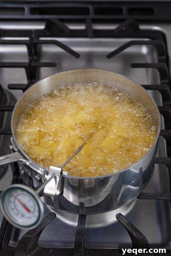 Fiery Spanish Patatas Bravas 8 Cubed potatoes frying to a golden crisp in hot oil.