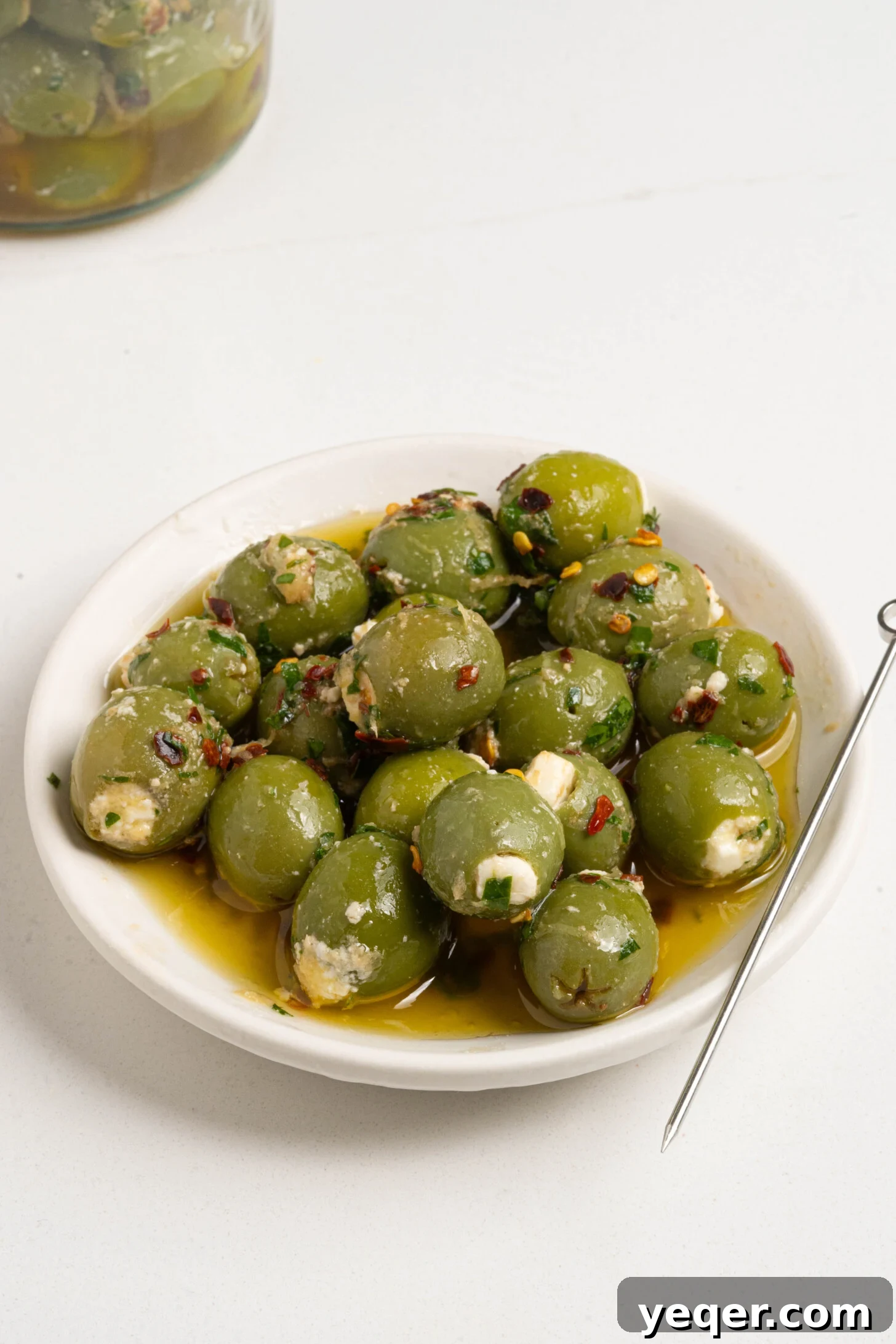 Exquisite Marinated Olives 2 Stuffed marinated olives artfully arranged on a serving plate.