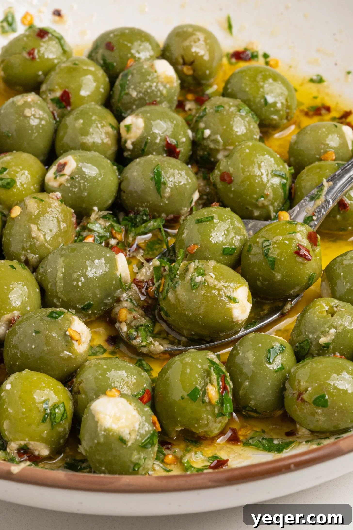 Exquisite Marinated Olives 7 A vibrant, inviting bowl of generously stuffed and richly marinated olives, beautifully arranged and ready to be served to eager guests.