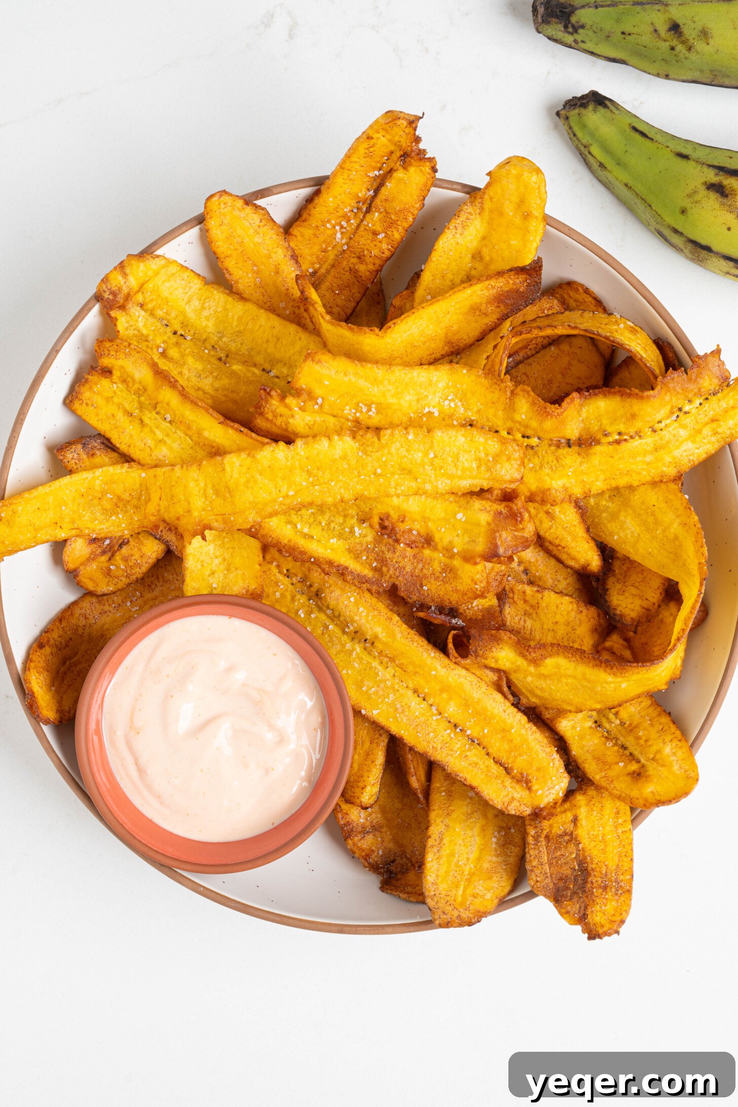 Crispy Plantain Delights 9 Close-up of crunchy fried plantain chips in a bowl with a focus on their crispy texture.