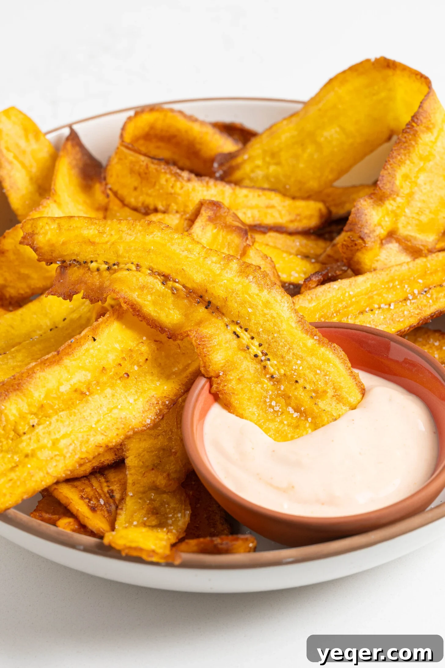 Crispy Plantain Delights 10 A large bowl of deep-fried plantain chips ready for sharing.