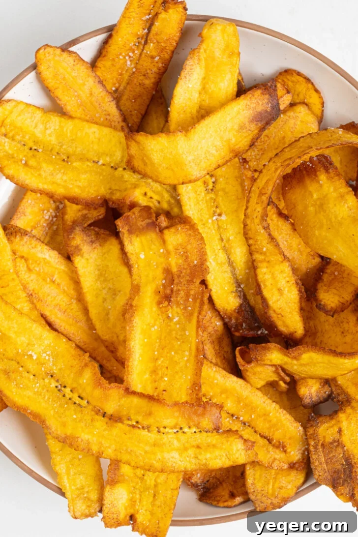 Crispy Plantain Delights 8 Crispy fried plantain chips piled high in a bowl.