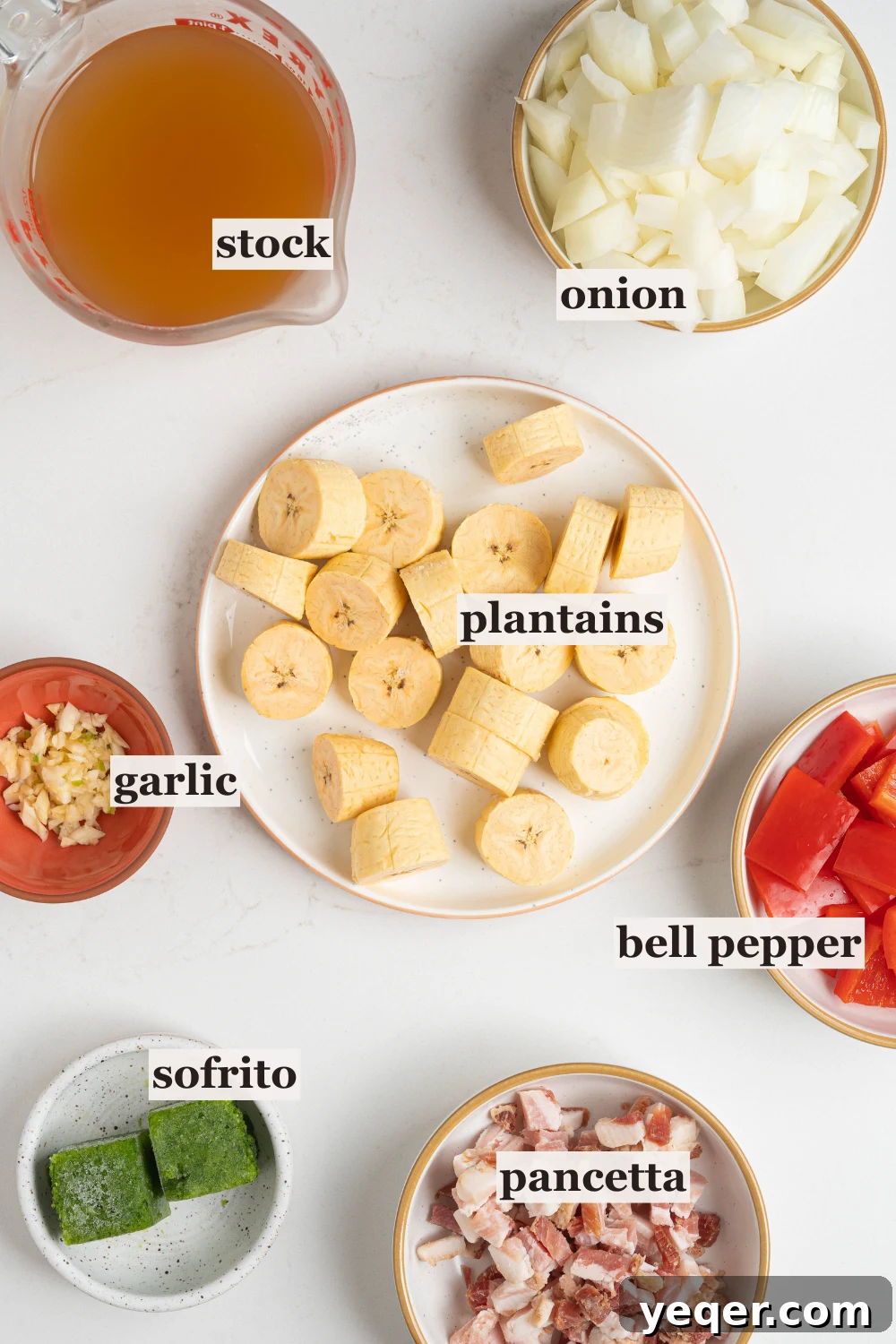 Bowls of chopped onion, plantain, garlic, and more.